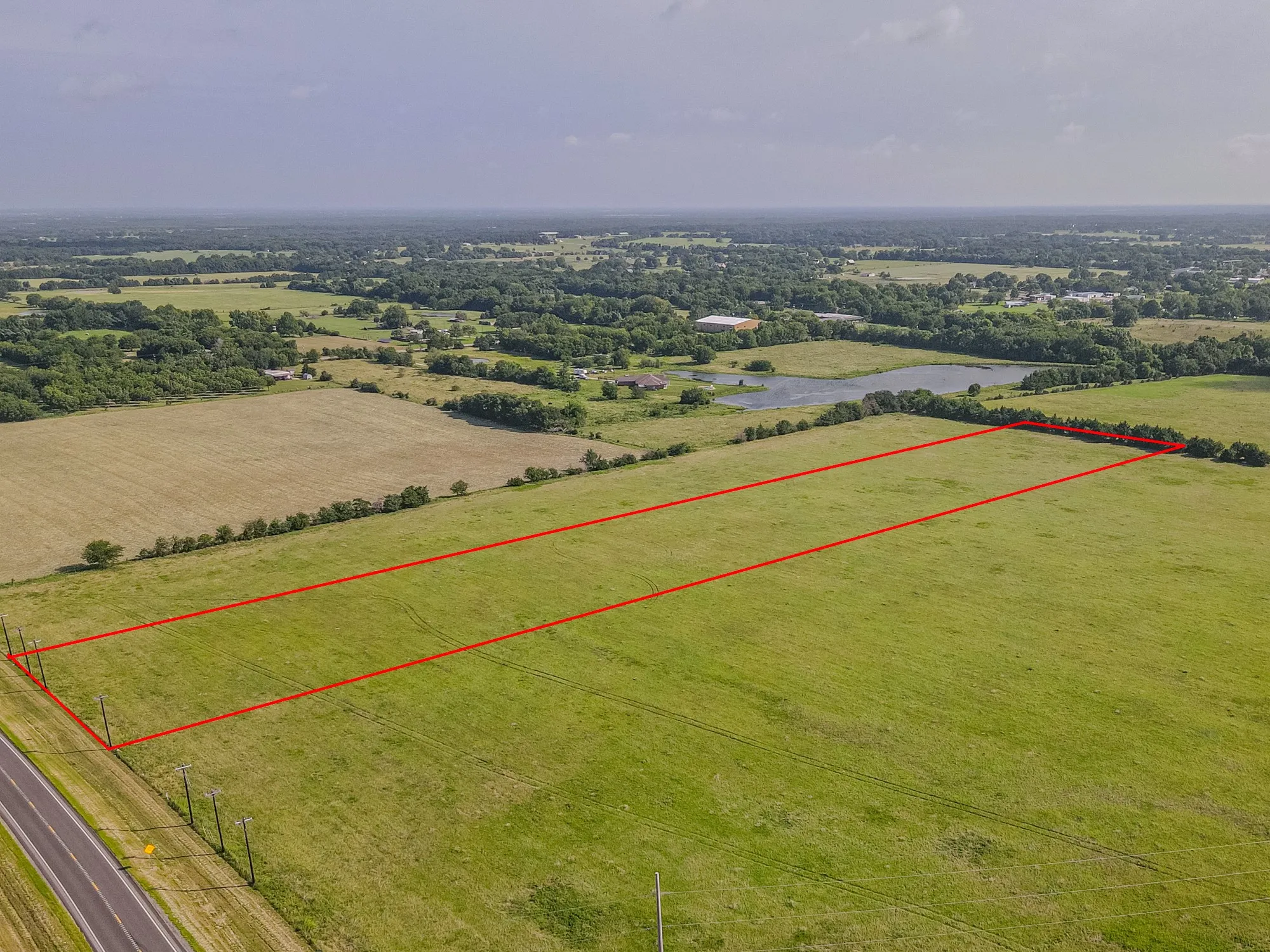 Expansive green field with a linear property outline