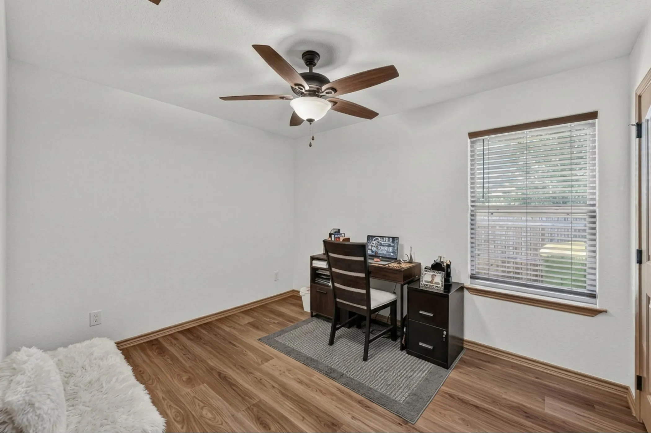 Neutral white walls with wood-finish flooring