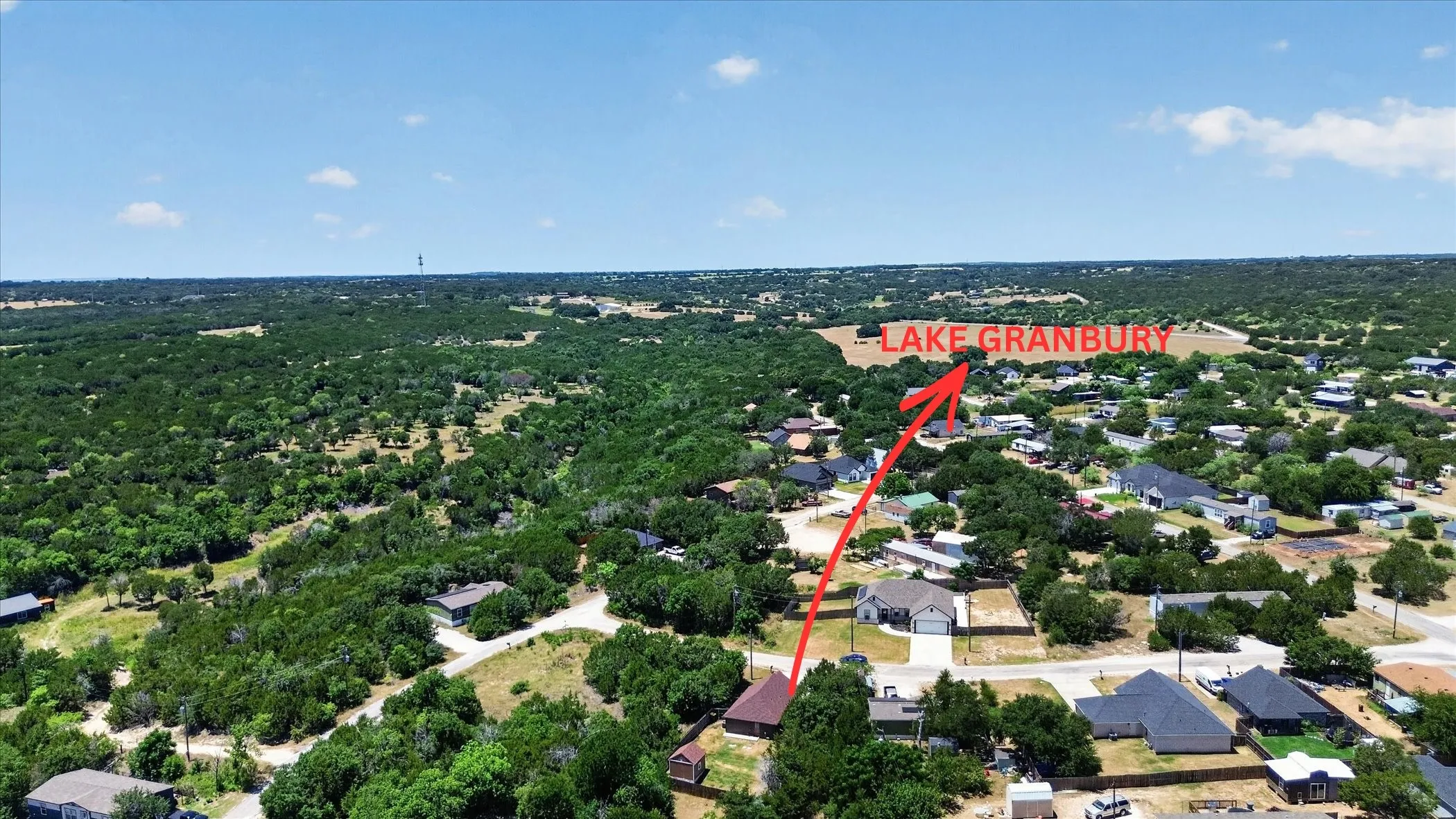 Aerial perspective showcasing a residential area amidst extensive green foliage