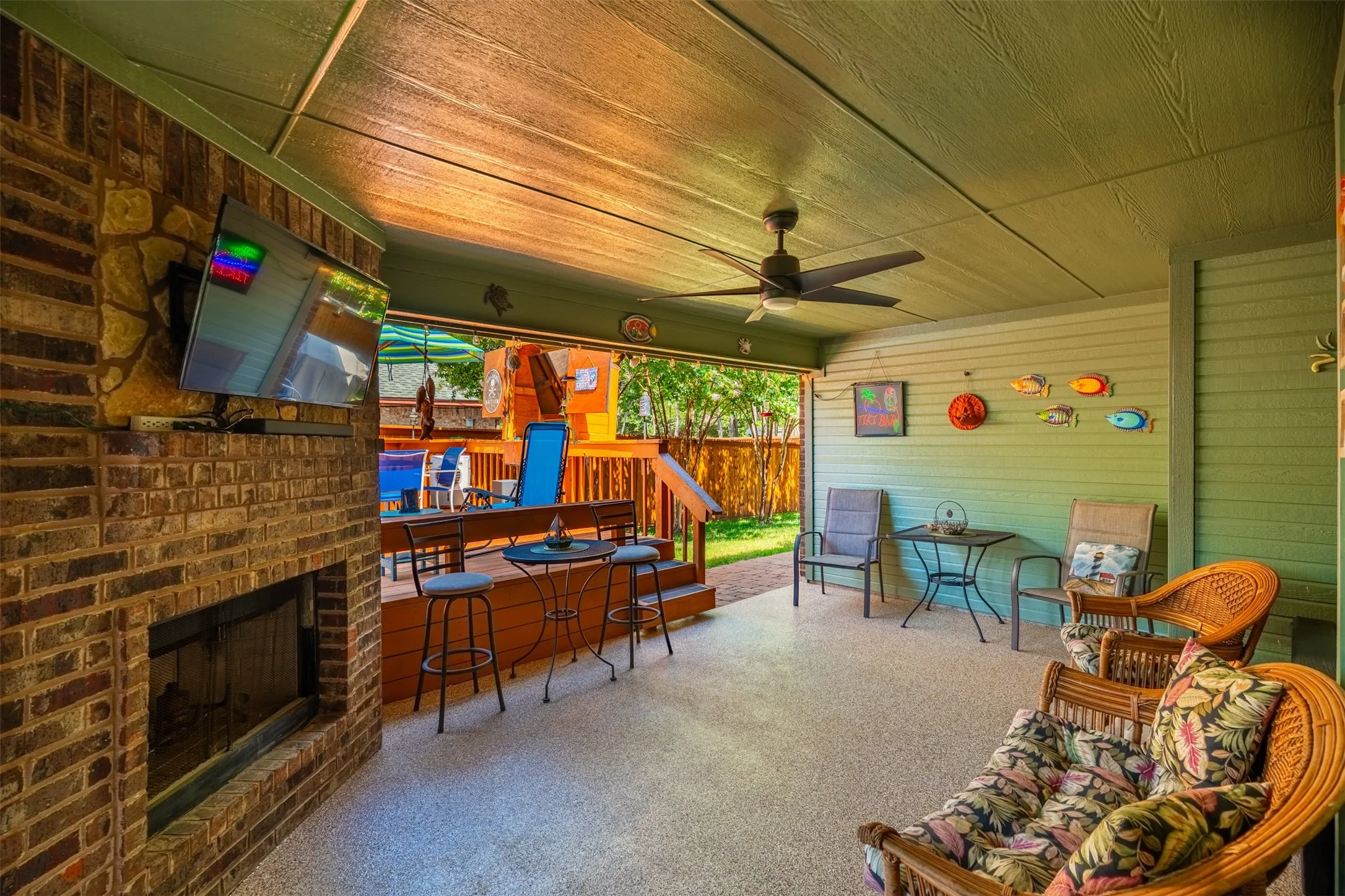 Back covered patio with fireplace.