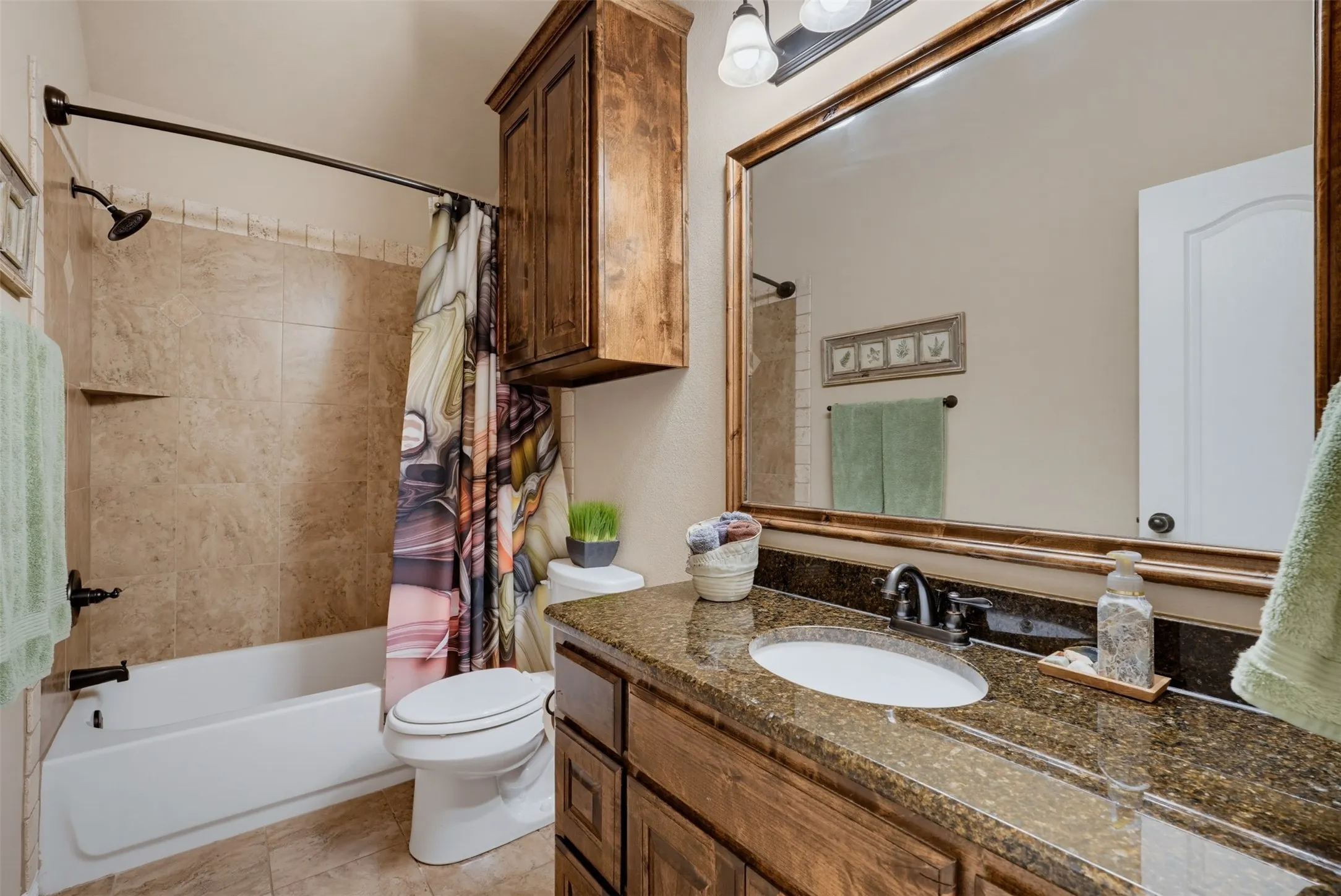 Granite countertop and tile tub surround