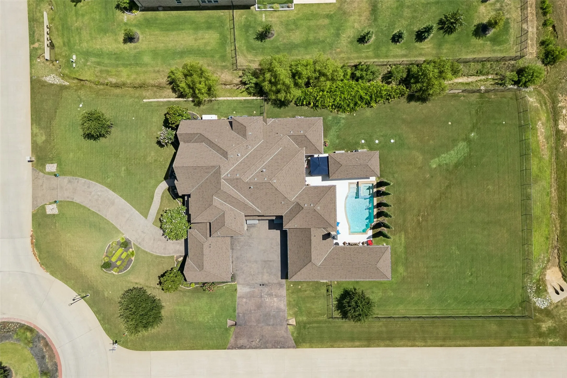 Expansive property featuring a multi-gabled roofline, a large inground swimming pool, a circular driveway, and a spacious lawn​​‌​​​​‌​​‌‌​‌‌​​​‌‌​‌​‌​‌​​​‌​​ area