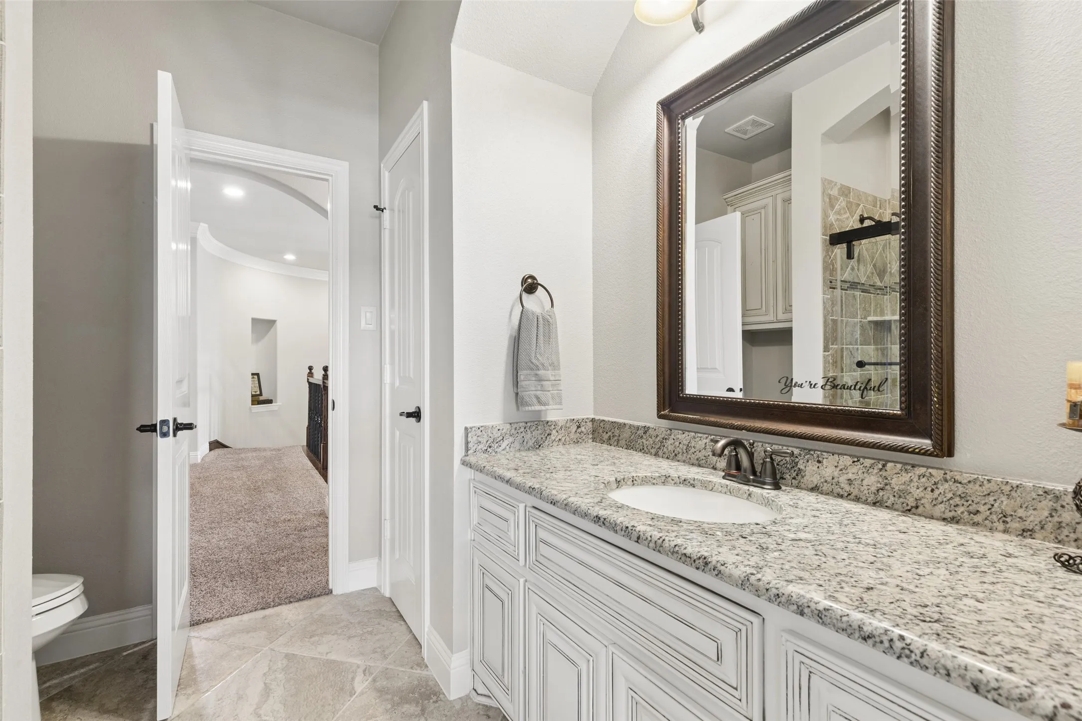 Vanity featuring a granite countertop with an undermount sink and oil-rubbed bronze faucet