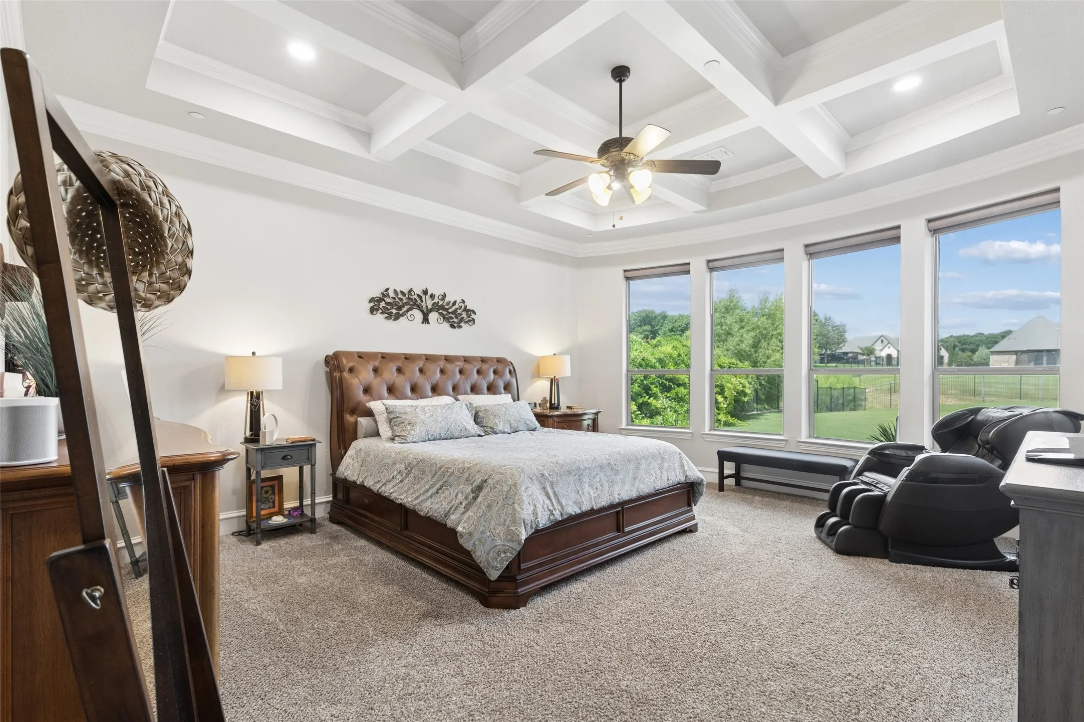 Expansive bedroom featuring a coffered ceiling, recessed lighting, and a ceiling fan