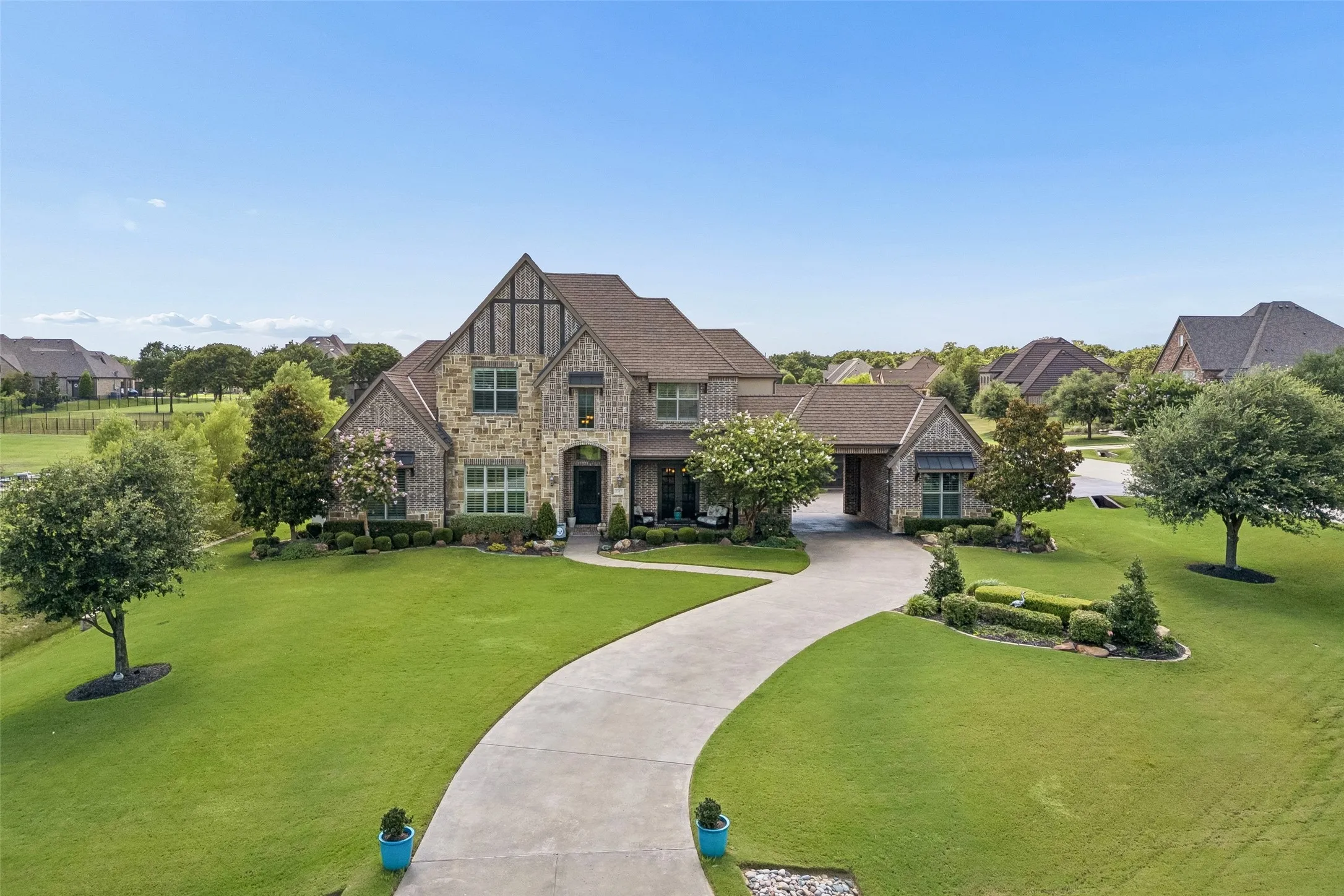 Stone and timber-frame exterior featuring a prominent gable, arched entry, and dark trim windows