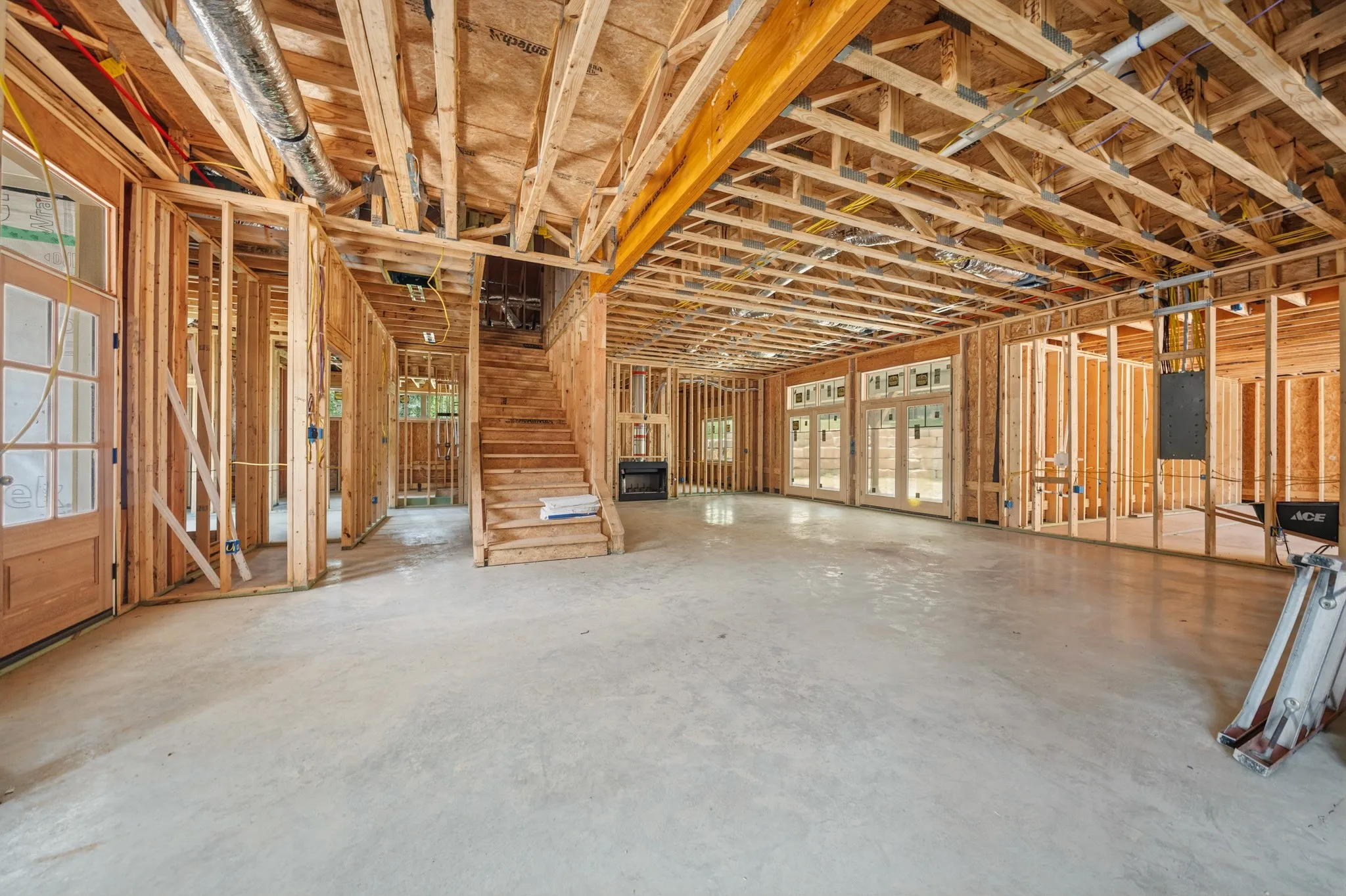 View from Kitchen island area across dining and Living areas to back porch