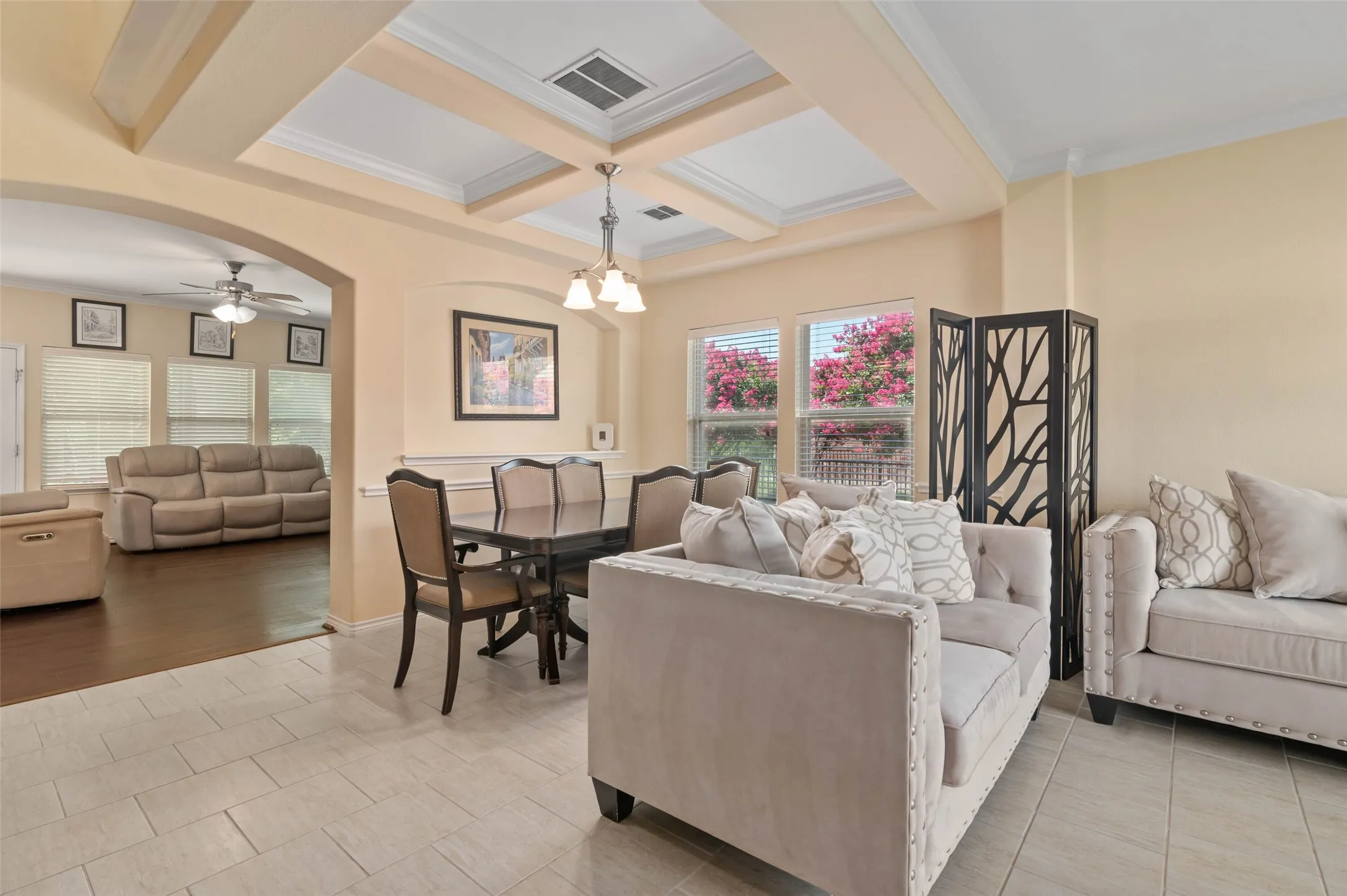 Coffered ceiling with crown molding and recessed lighting