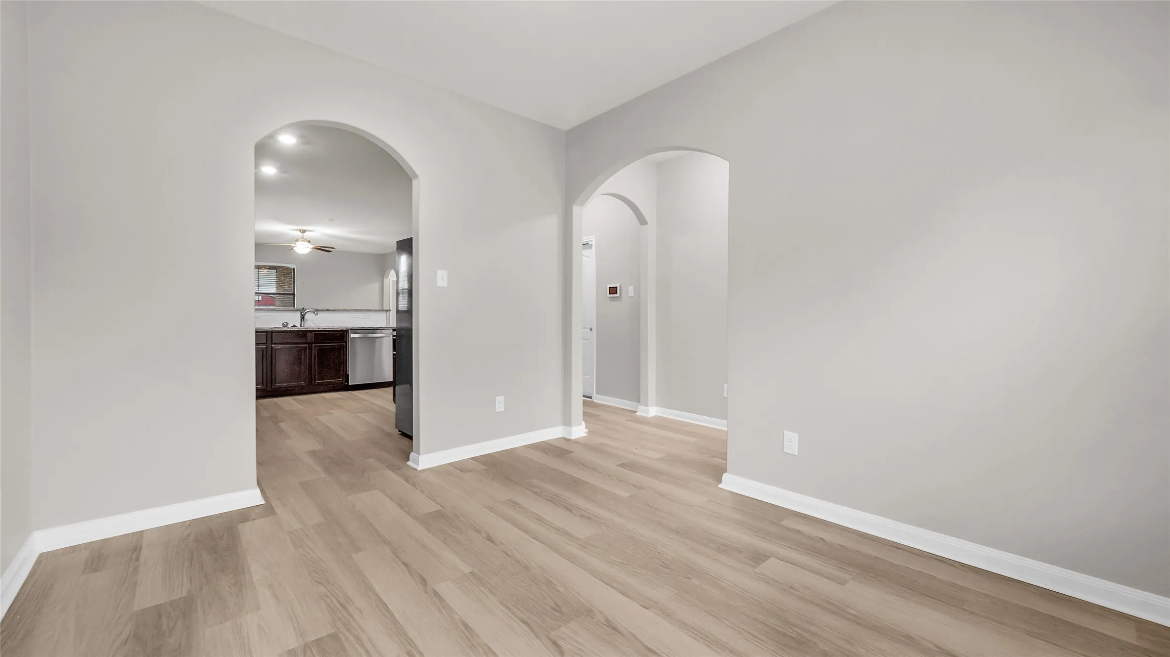 View from dining area to the kitchen and main entry.