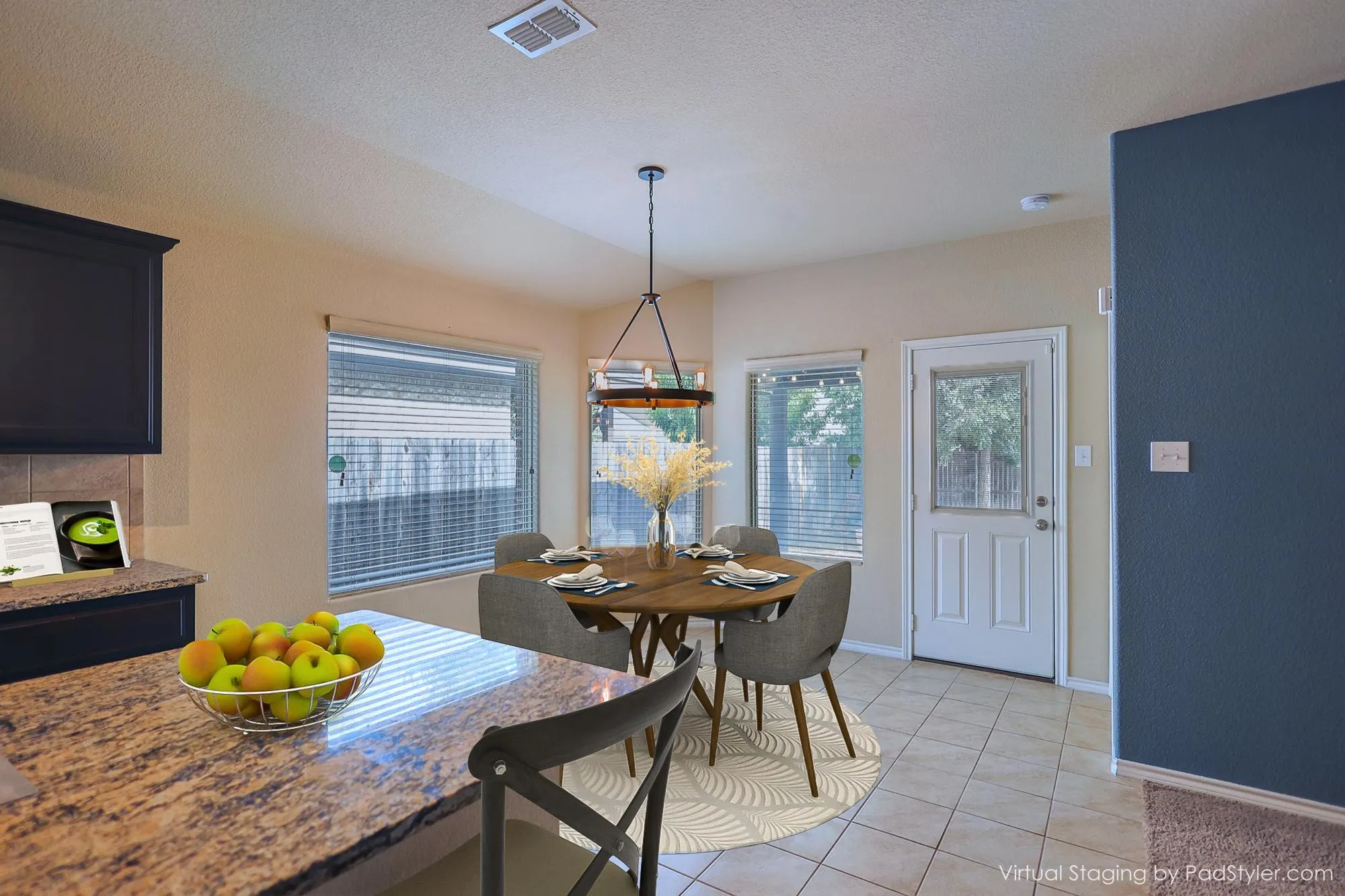 Kitchen with dark cabinetry, speckled countertops, and an integrated backsplash