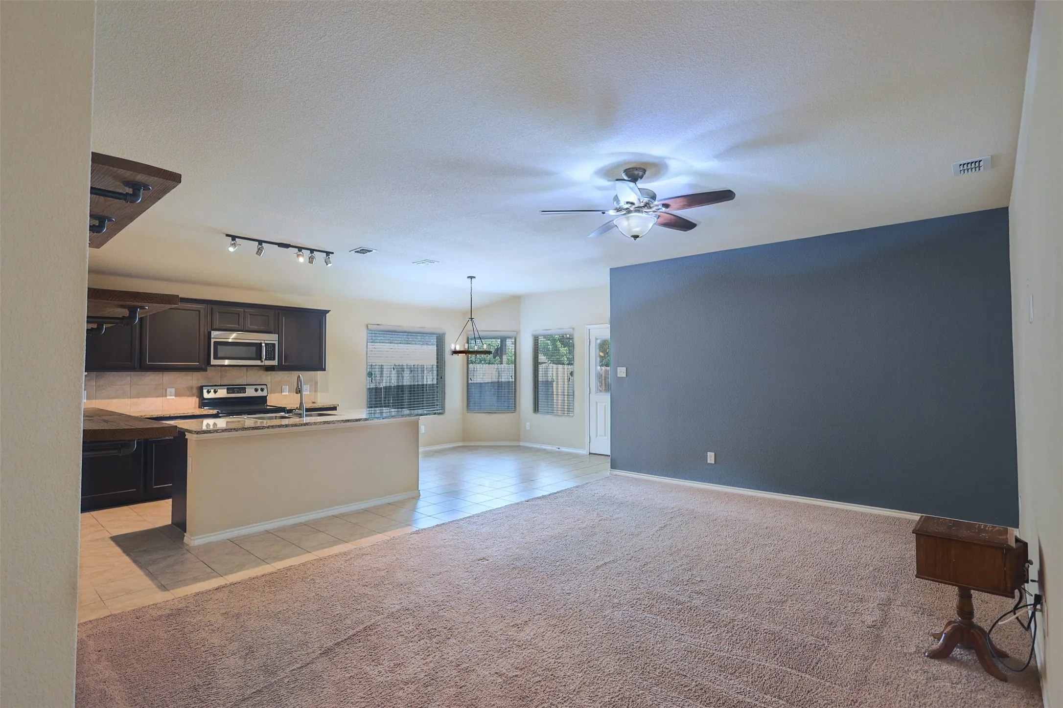Spacious & Open Living Room With Attractive Accent Colors For Warmth!