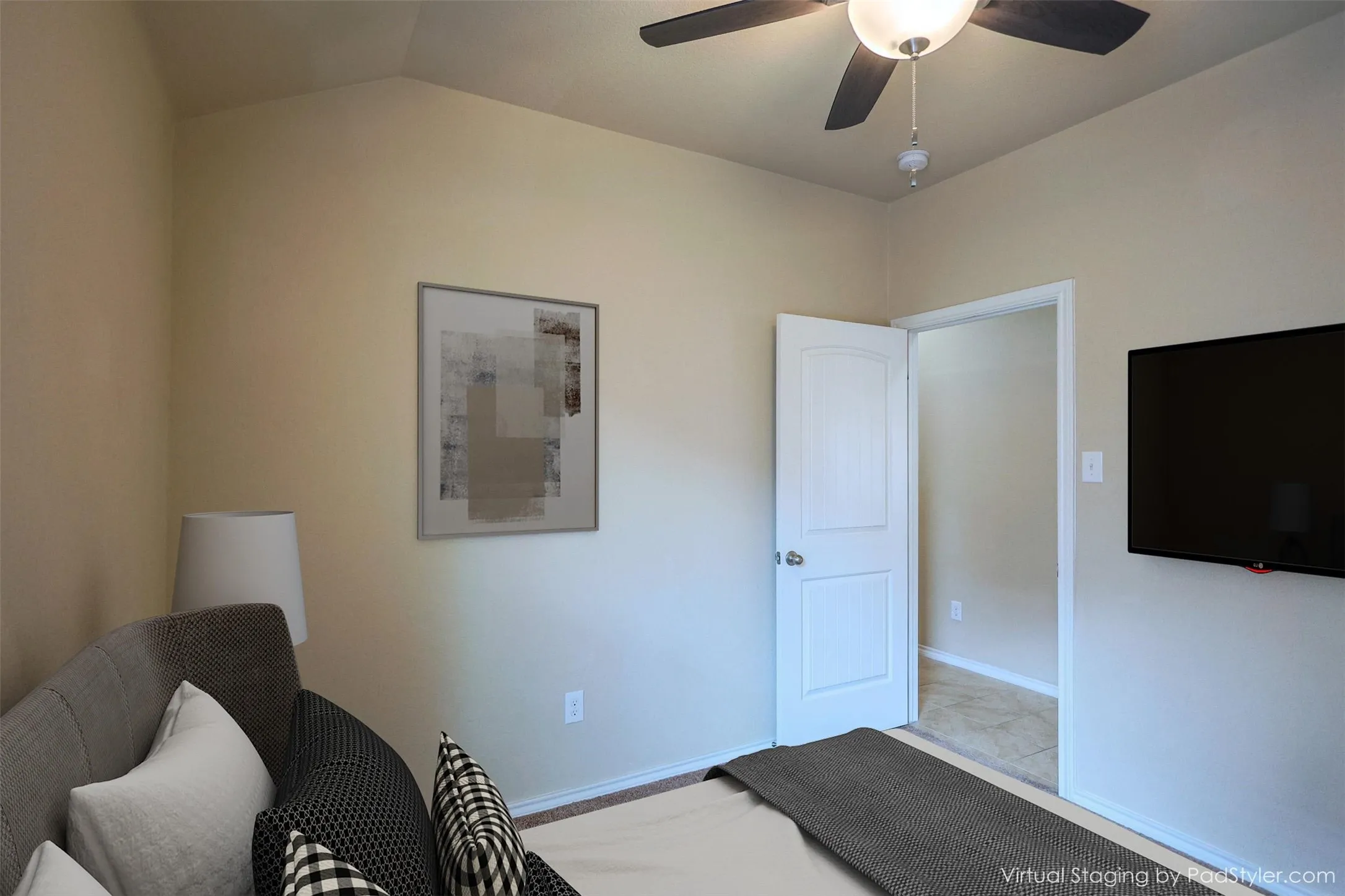 Large Primary Bedroom featuring vaulted ceiling, ceiling fan, neutral wall tones, and wood-finish flooring visible through the doorway