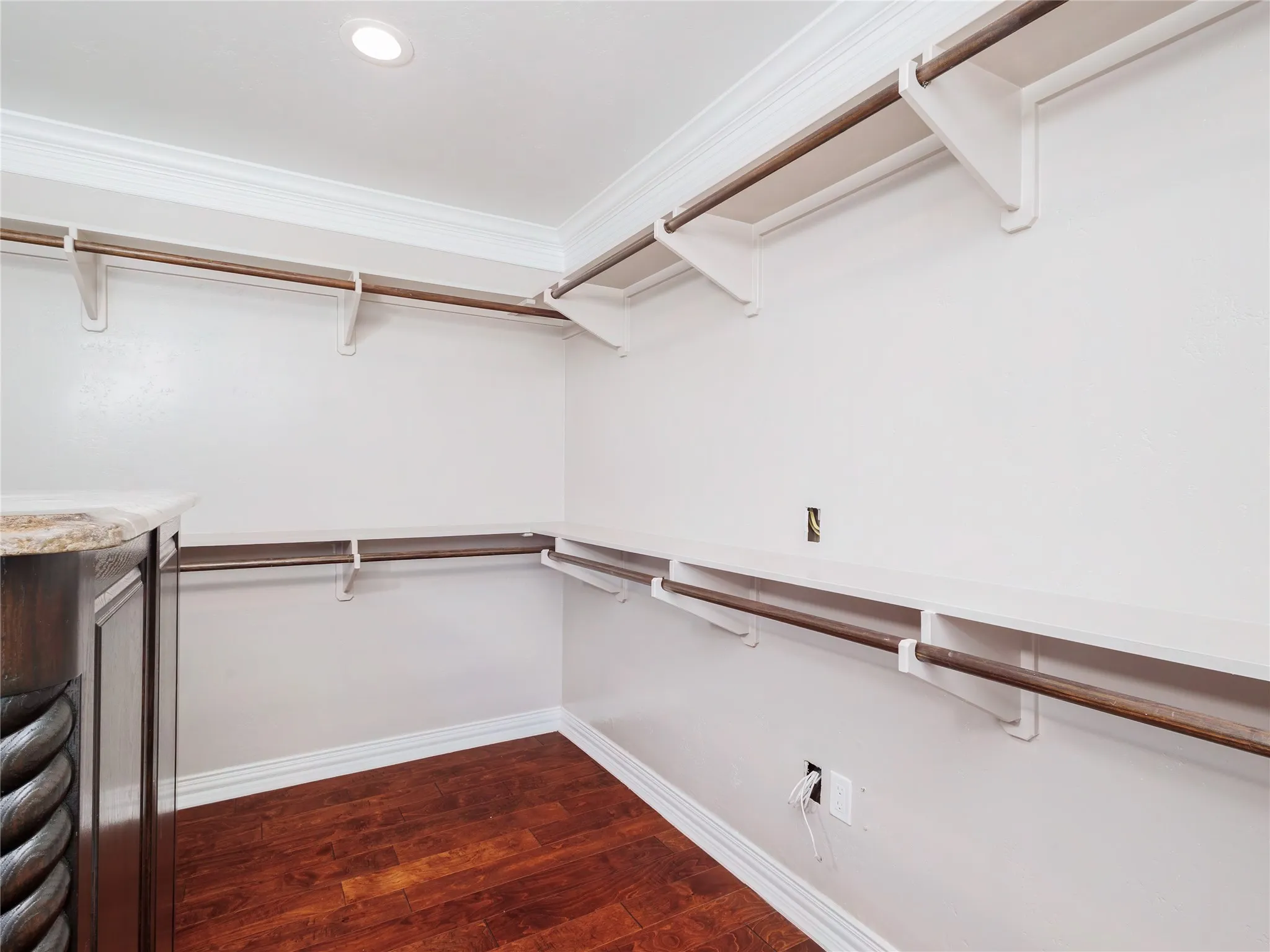 Custom closet system featuring built-in shelving and hanging rods