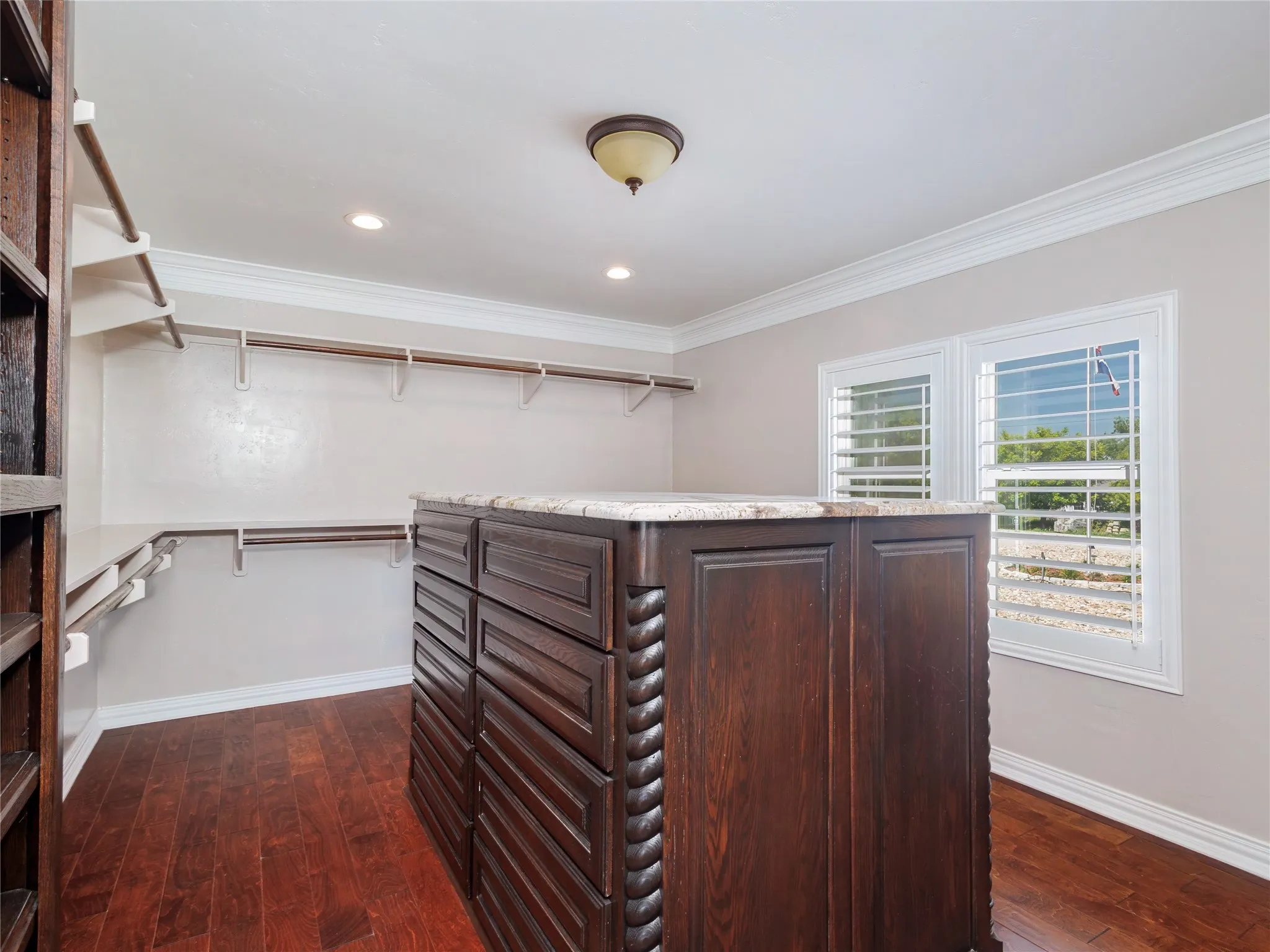 Hardwood-finish flooring complementing a central custom island with a light-toned countertop
