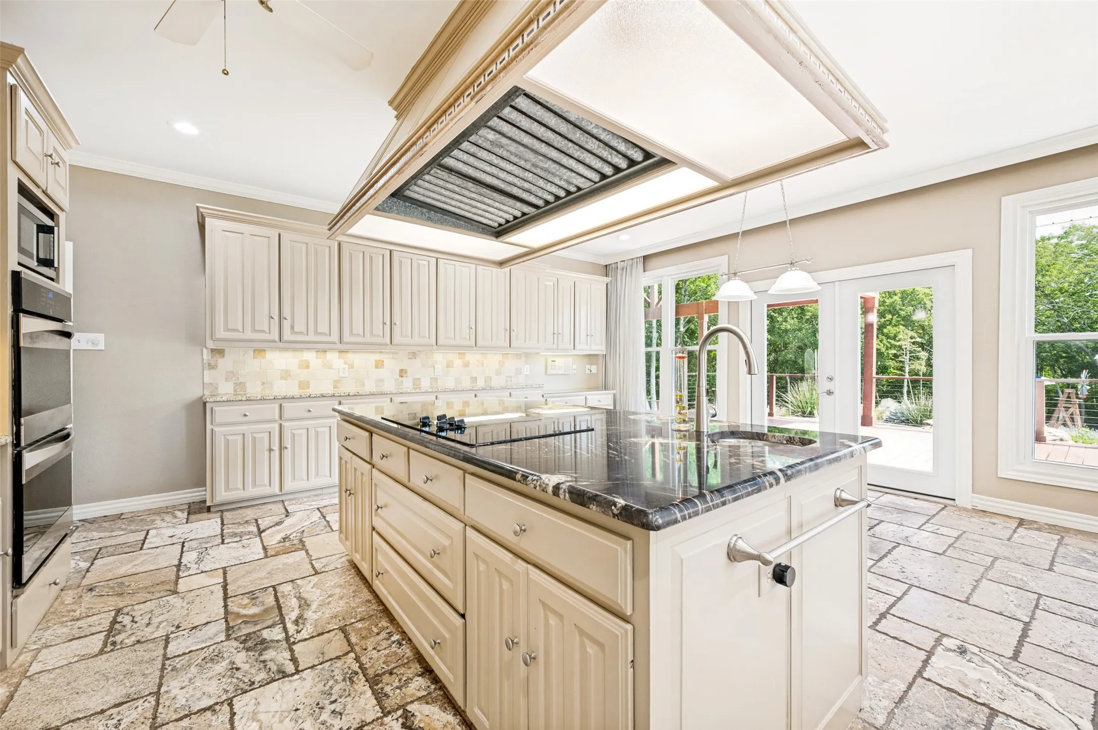 The island counter was recently replaced. It houses the electric cooktop and a 2nd sink!
