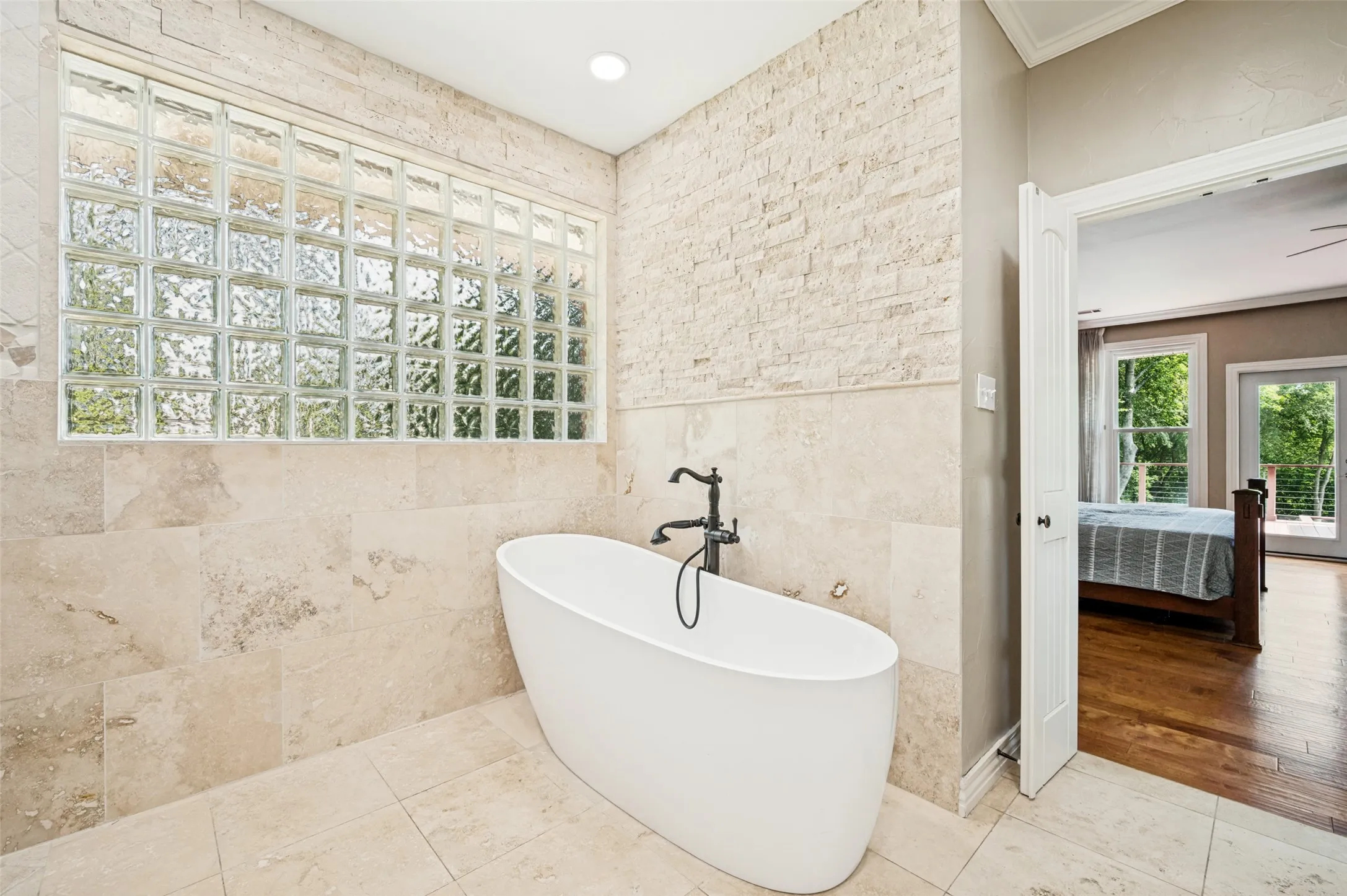 Stand alone tub and large window that adds natural light and privacy in the Primary bath.