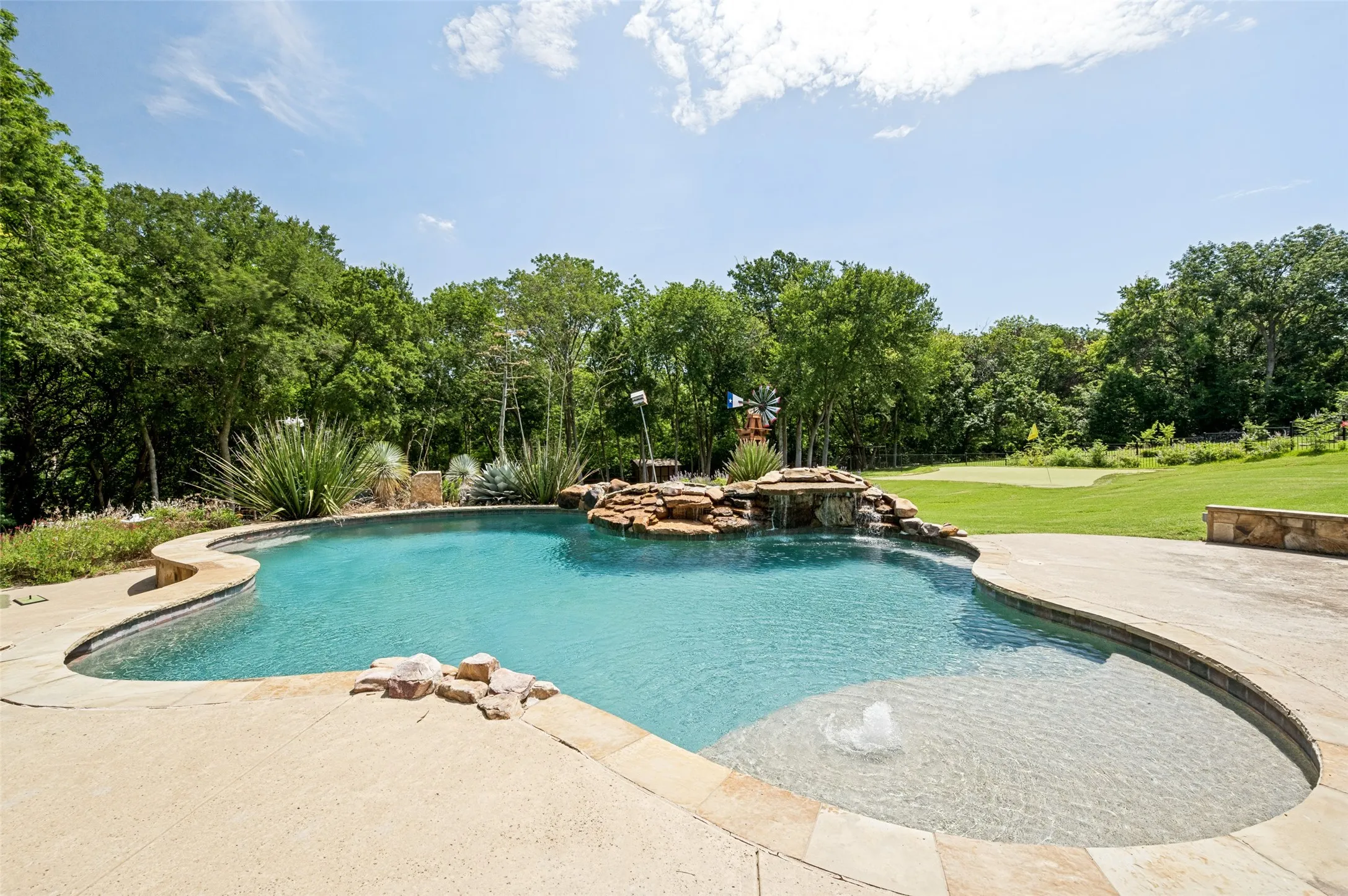Custom pool with sundeck and waterfalls; the deepest is 6 ft.