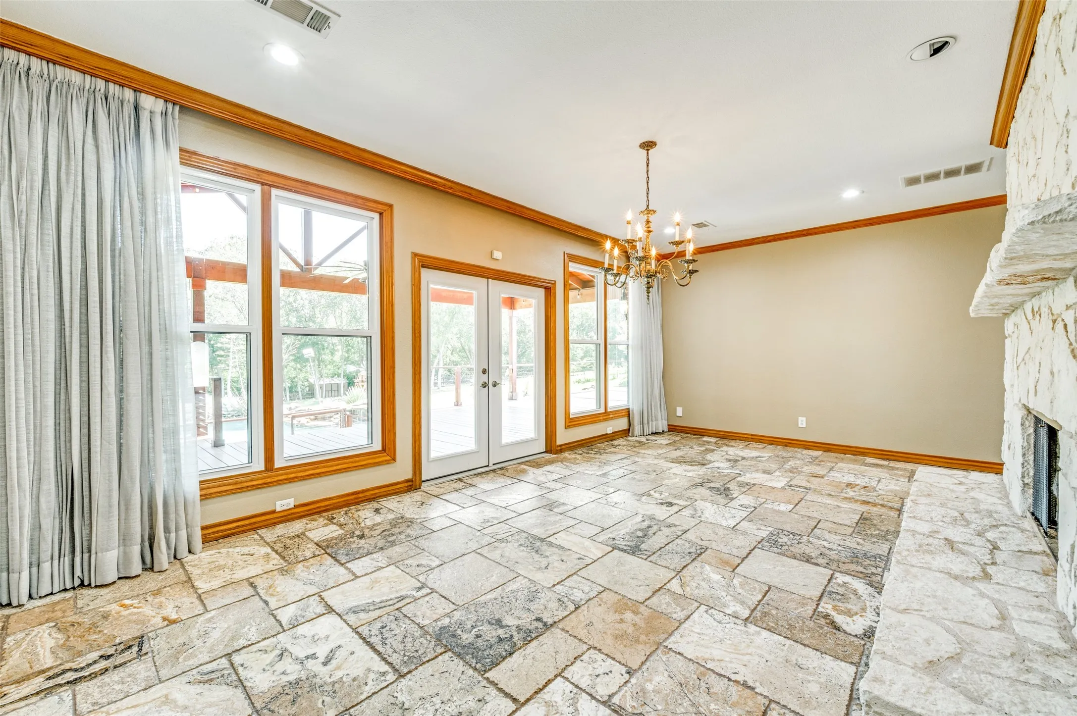 This side of the fireplace is ready as a dining room or whatever you want it to be! It looks out over the covered porch which makes entertaining easy.