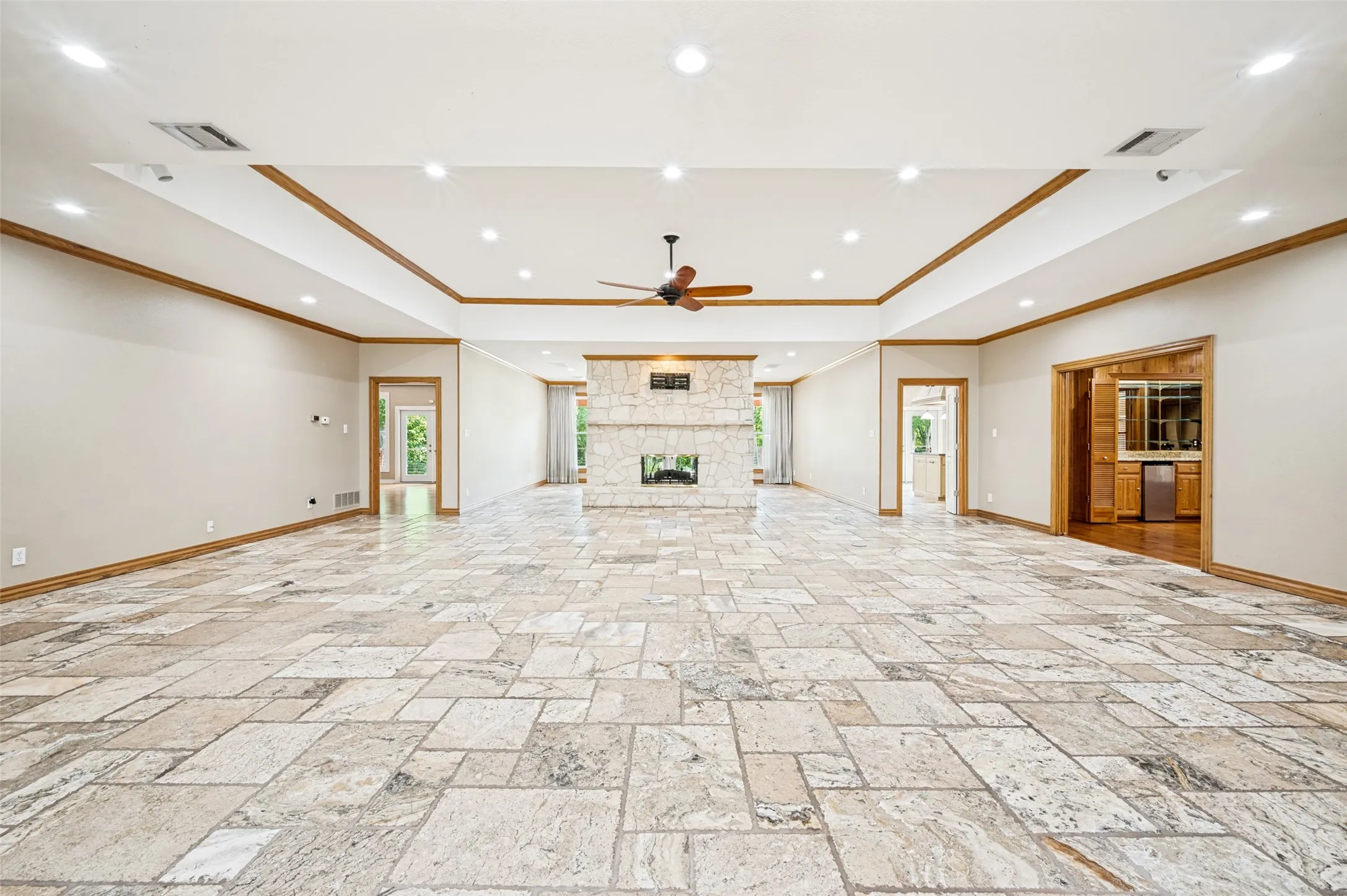 Walking in the front door and enter the huge living room with a beautiful tray ceiling and natural wood!
