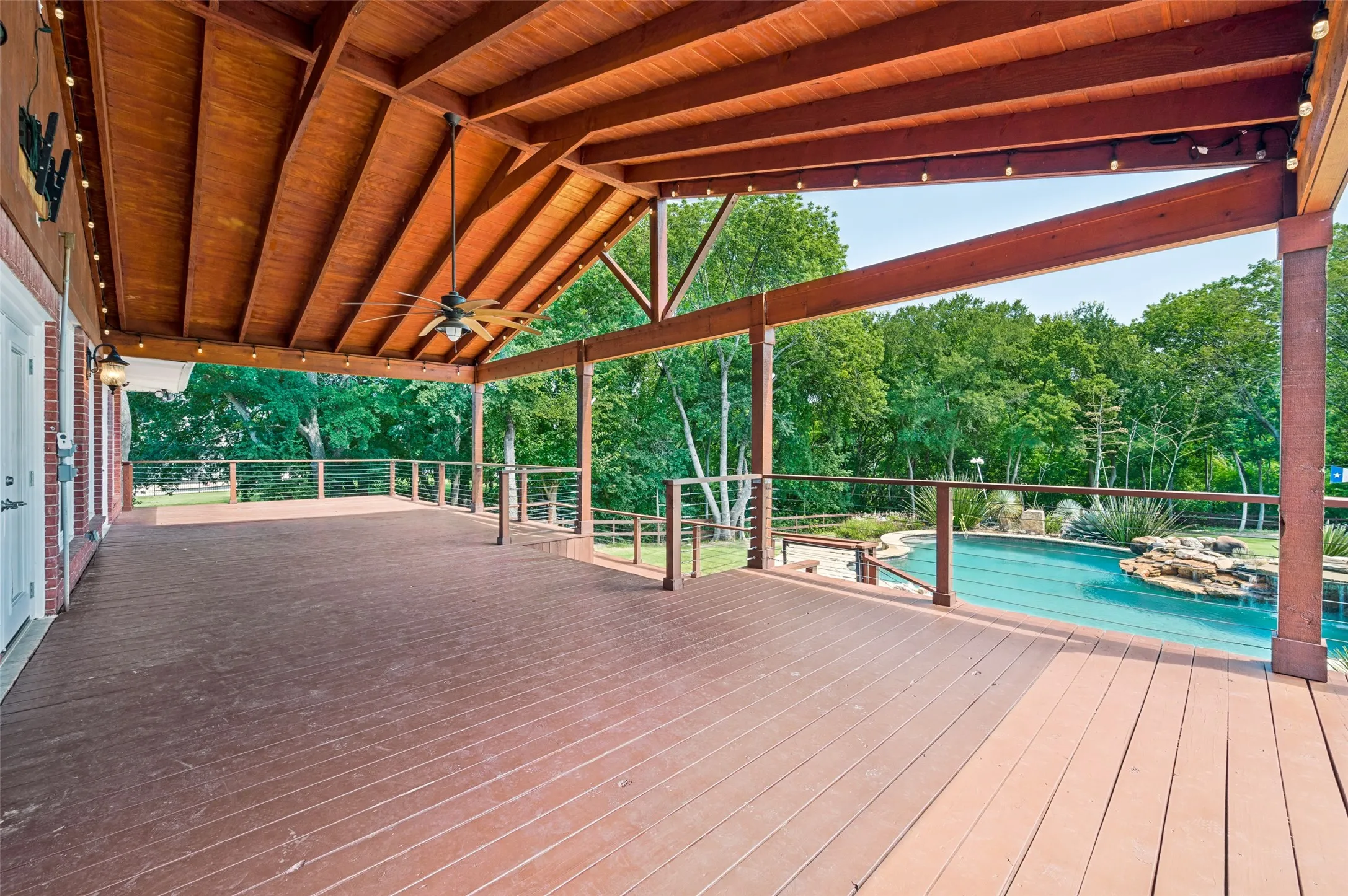 The huge Deck or Porch  overlooks the pool and waterfall.