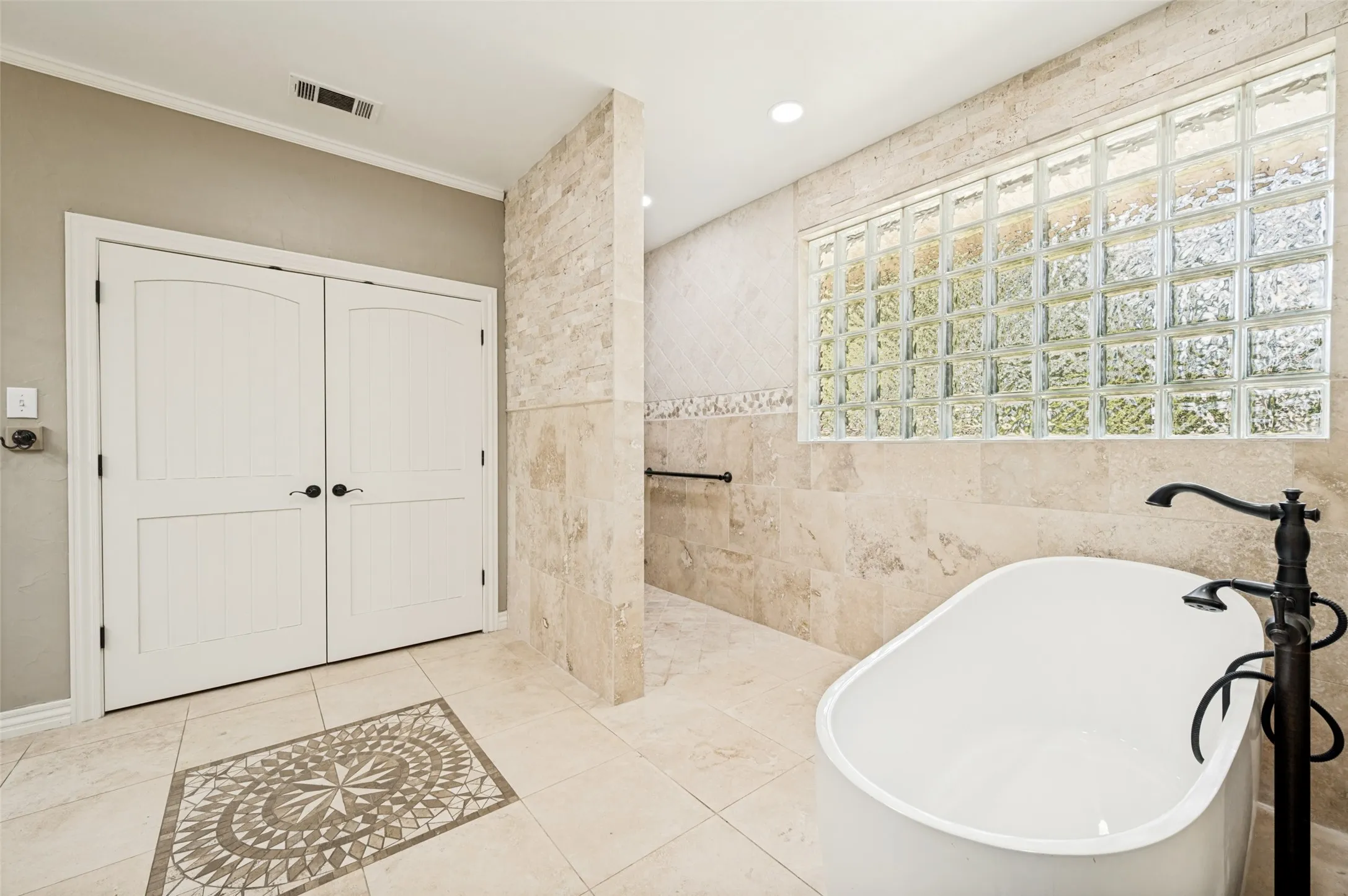 Walk-in shower, standalone tub and the doors lead to 1 of 3 closets.
