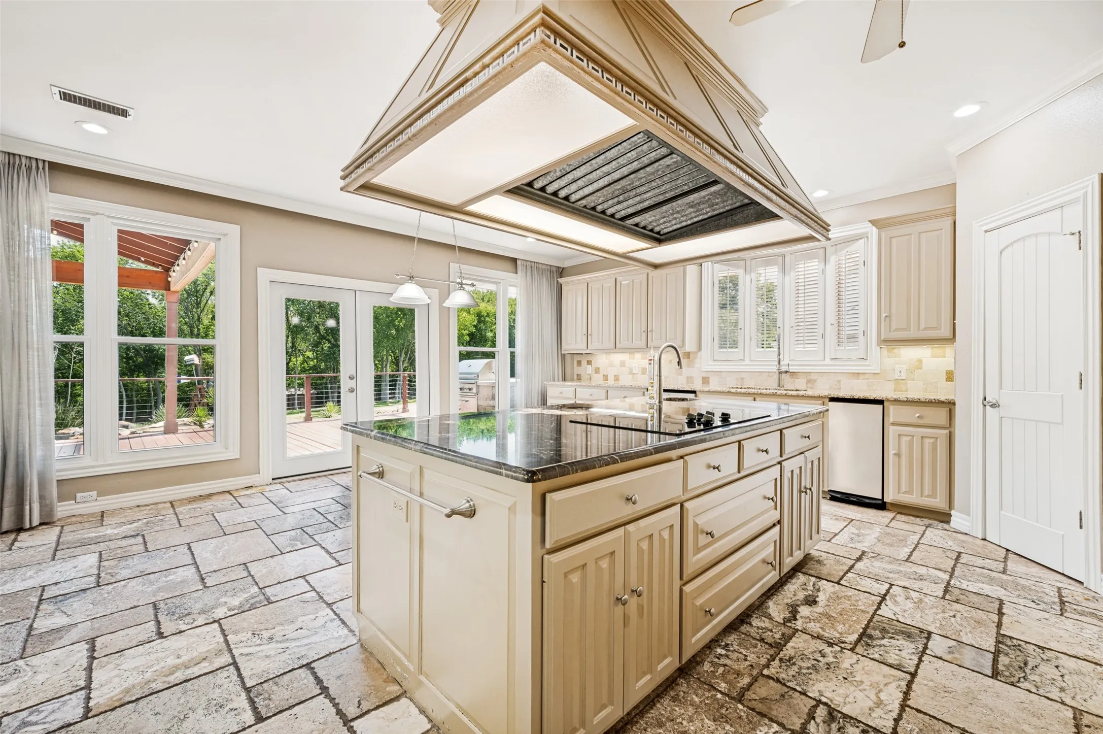 The kitchen walks out onto the back porch with a built-in grill.