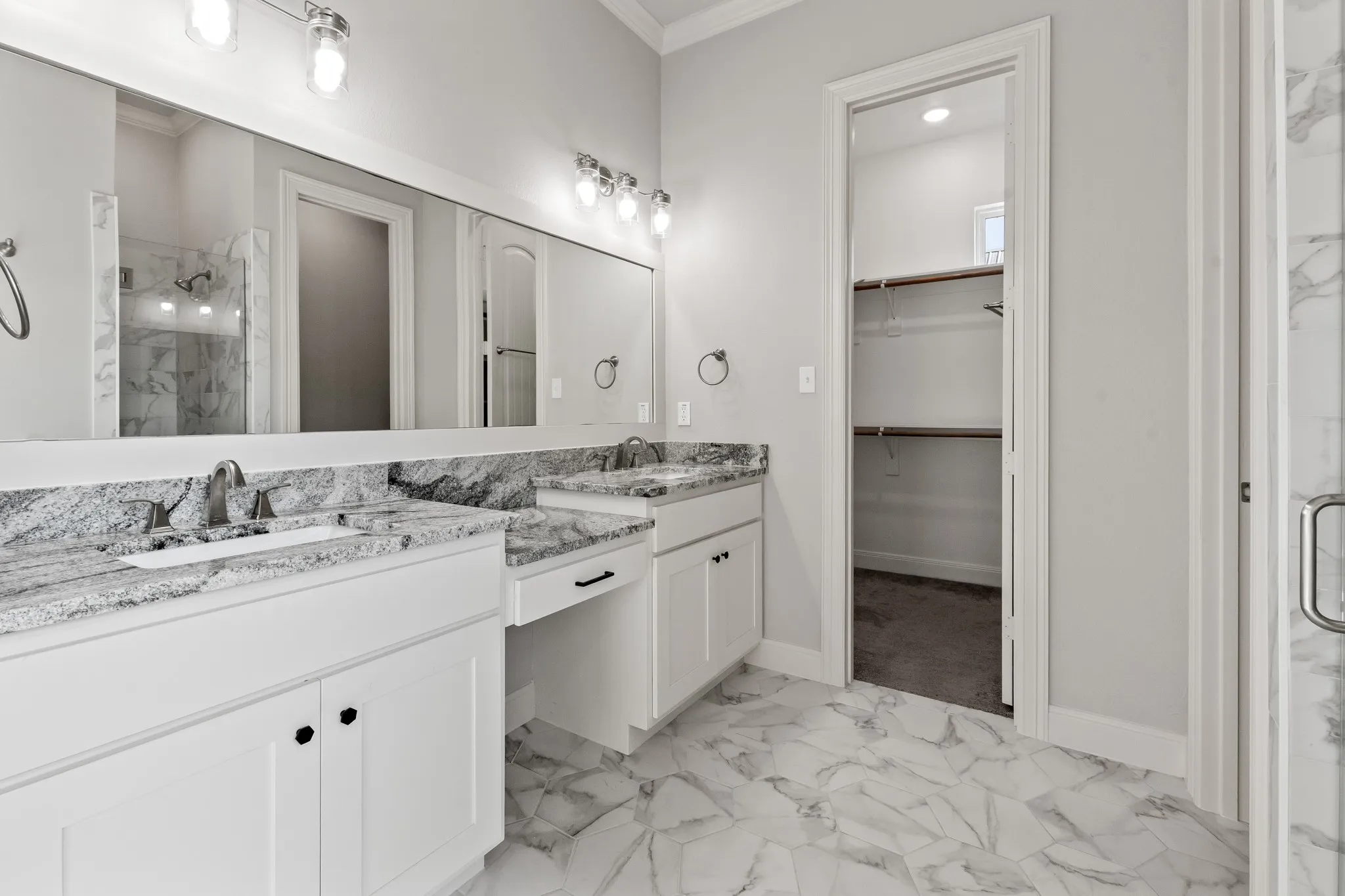 Double sink vanity with granite counter tops and spacious walk in closet.