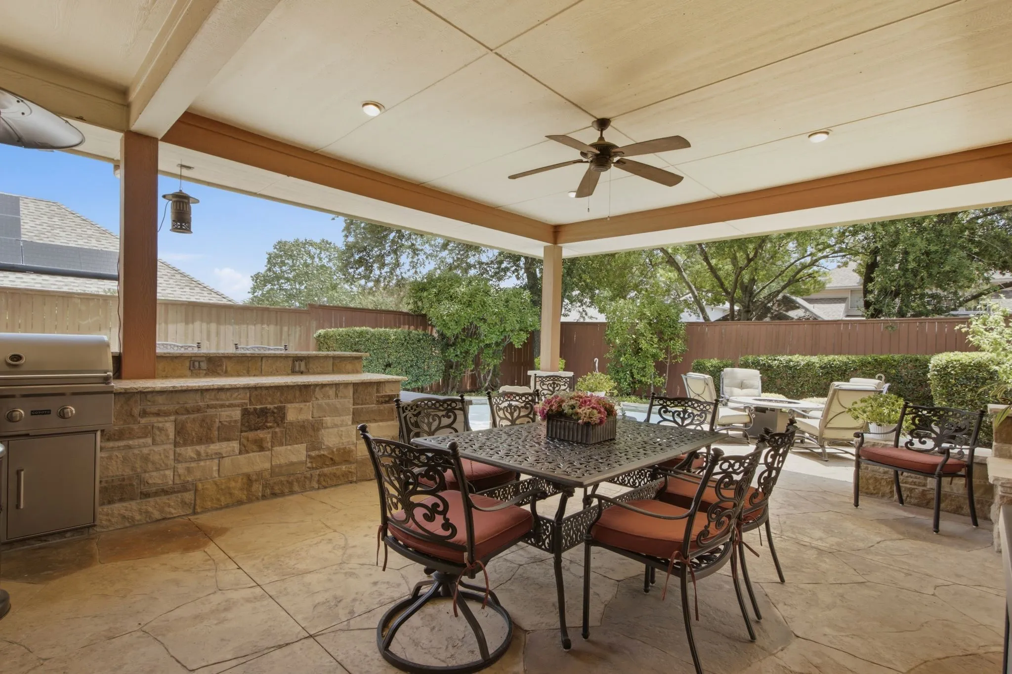 Covered outdoor living area featuring stamped concrete flooring