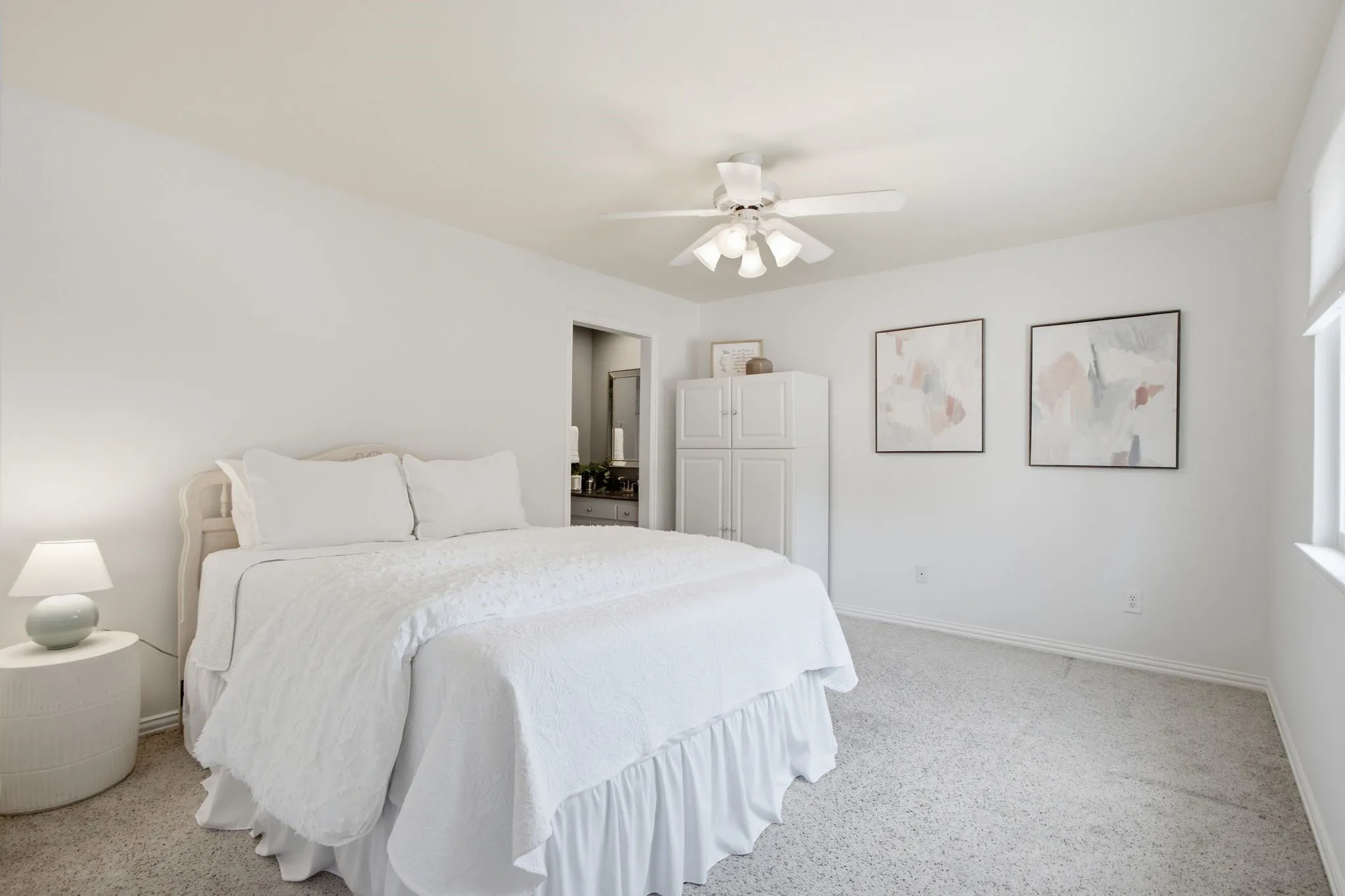 Bright room with neutral wall paint and light-colored carpet flooring
