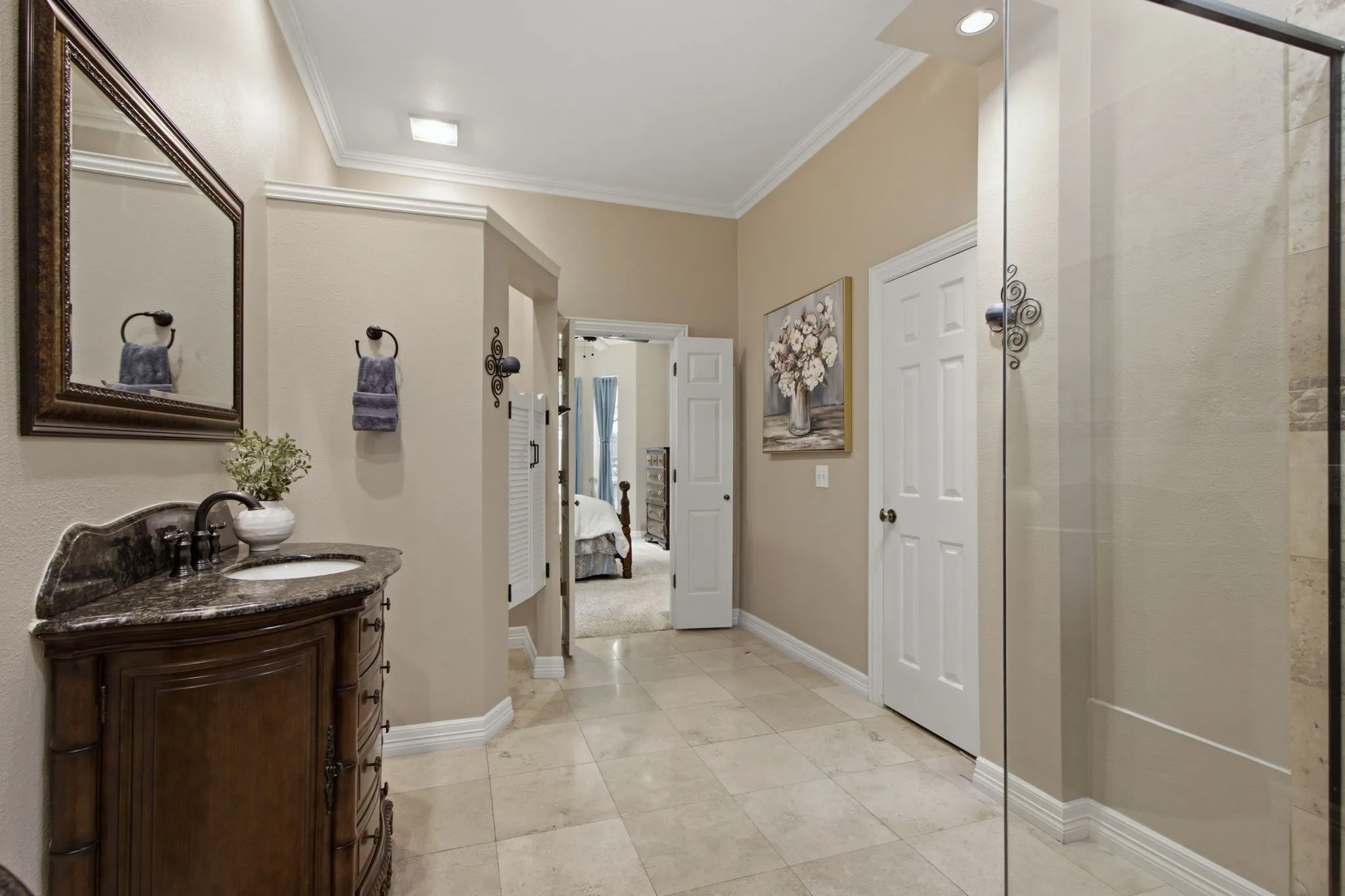 Bathroom vanity featuring a dark wood cabinet, vessel sink, and an ornate framed mirror