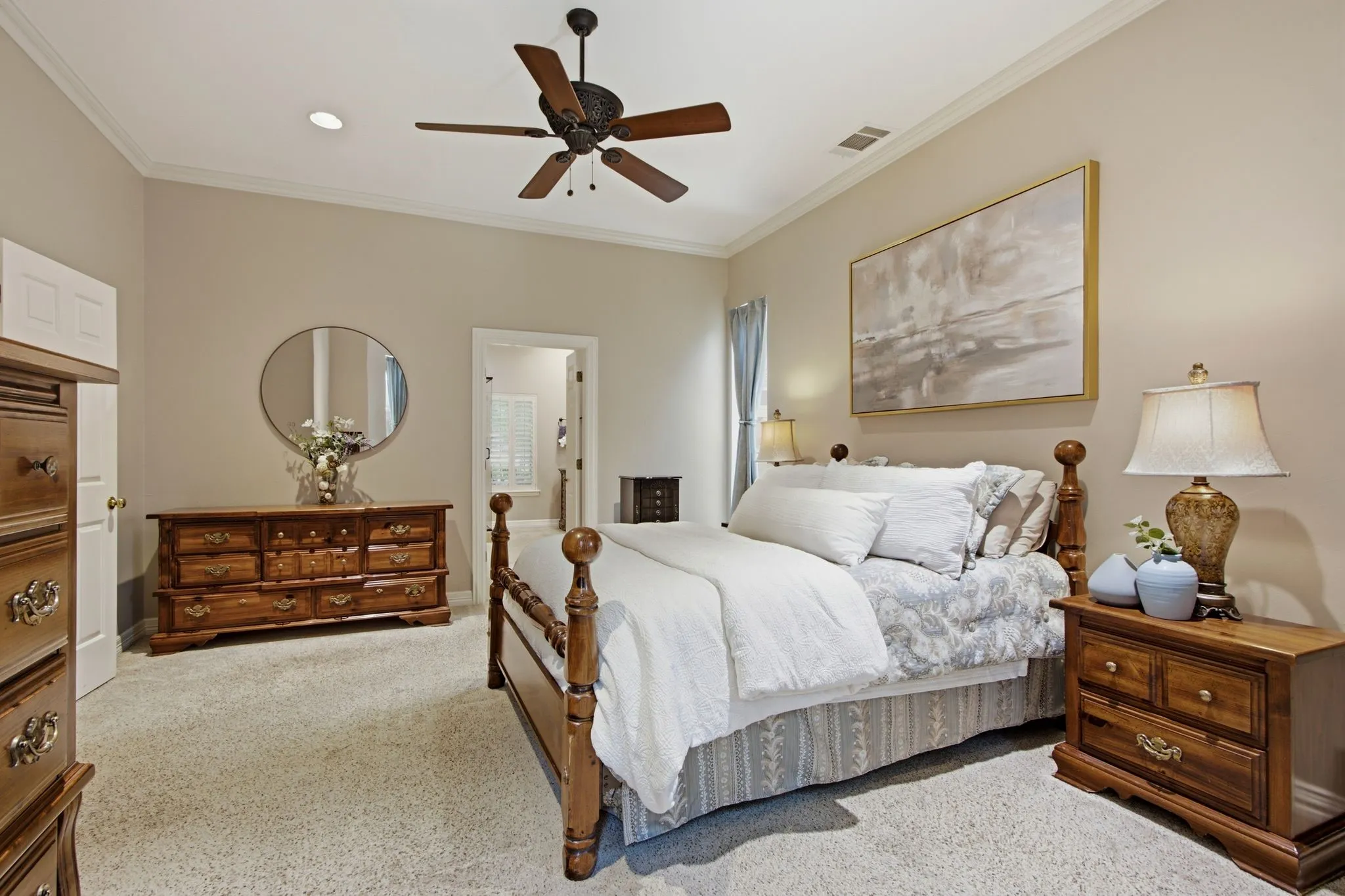Carpeted bedroom featuring a vaulted ceiling with crown molding, a ceiling fan with integrated lighting, and an open doorway leading to another area