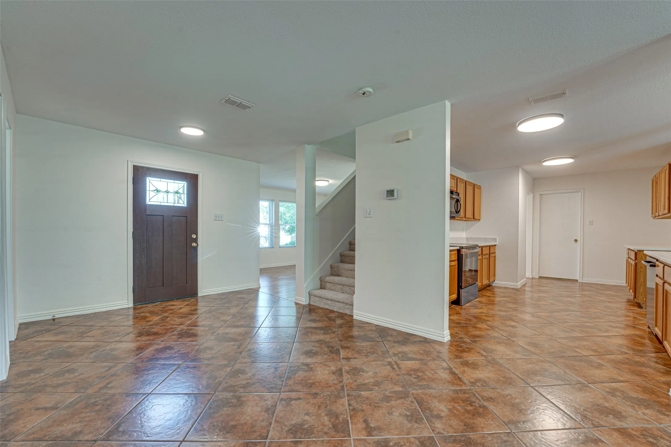 Spacious interior with large format tile flooring throughout