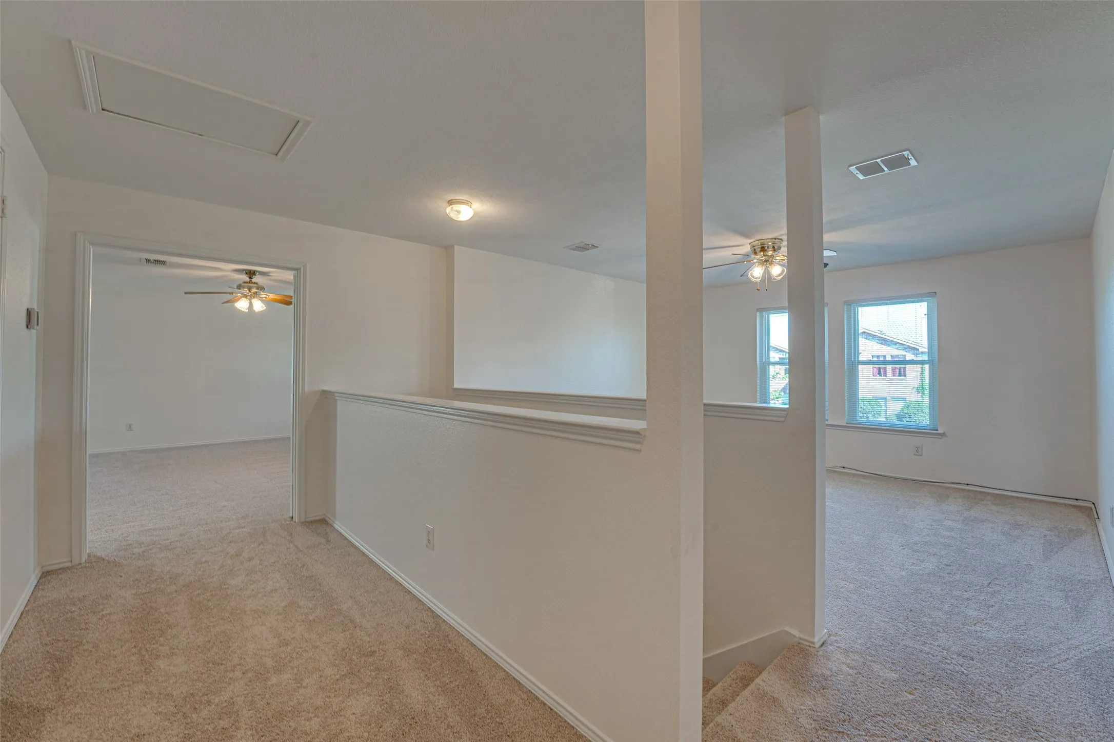 Carpeted hallway with painted walls, recessed lighting, and a ceiling access panel