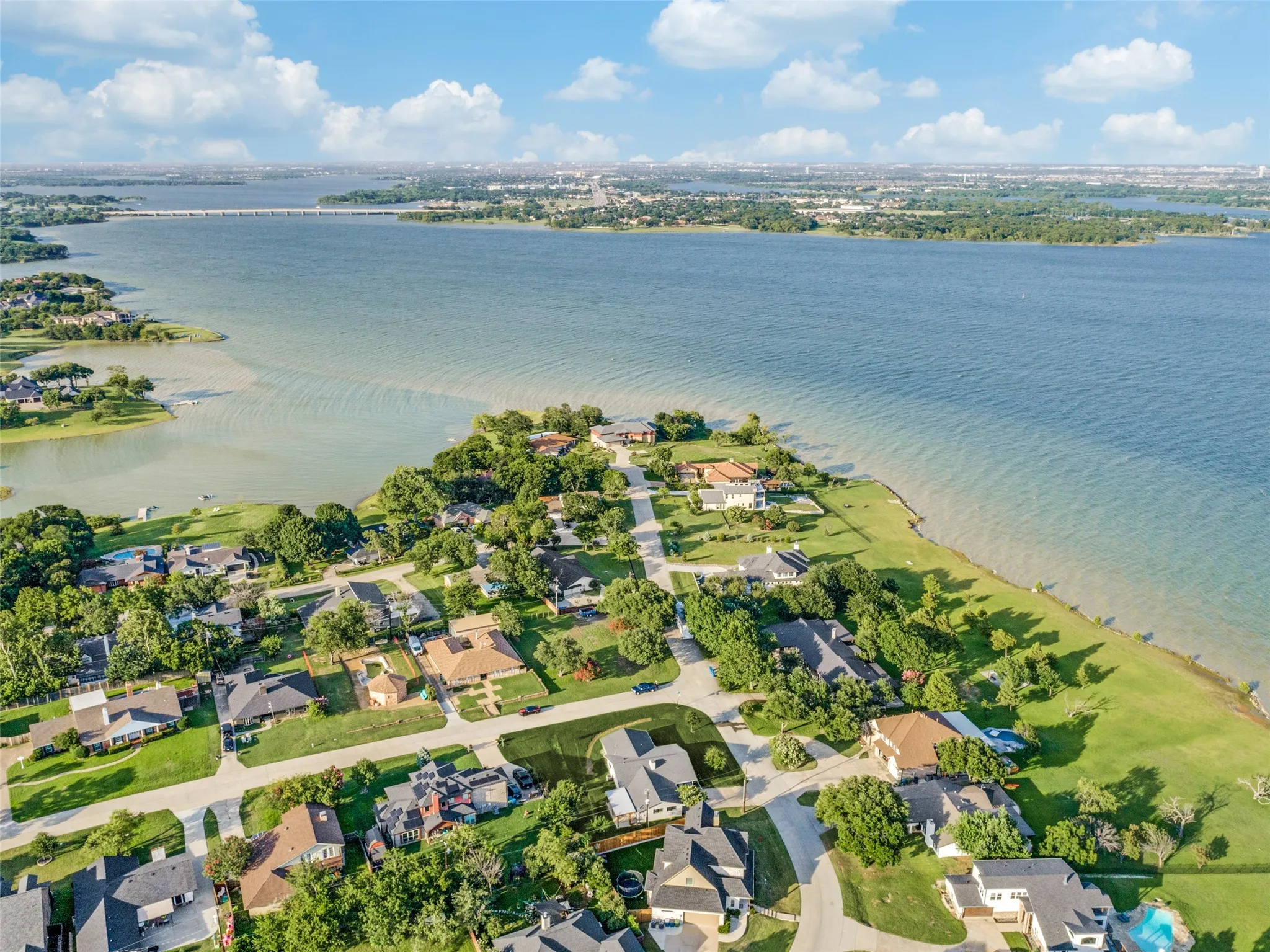 Waterfront properties featuring diverse architectural styles, mature landscaping, and established residential streets
