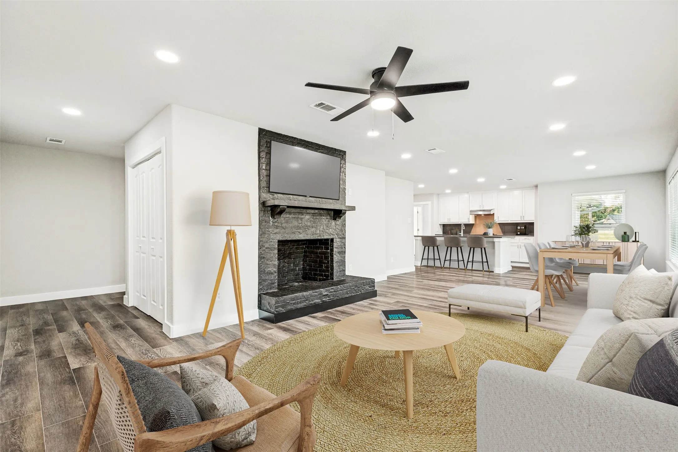 Virtually Staged-Open-concept living area featuring wood-finish flooring, a contemporary ceiling fan, and recessed lighting