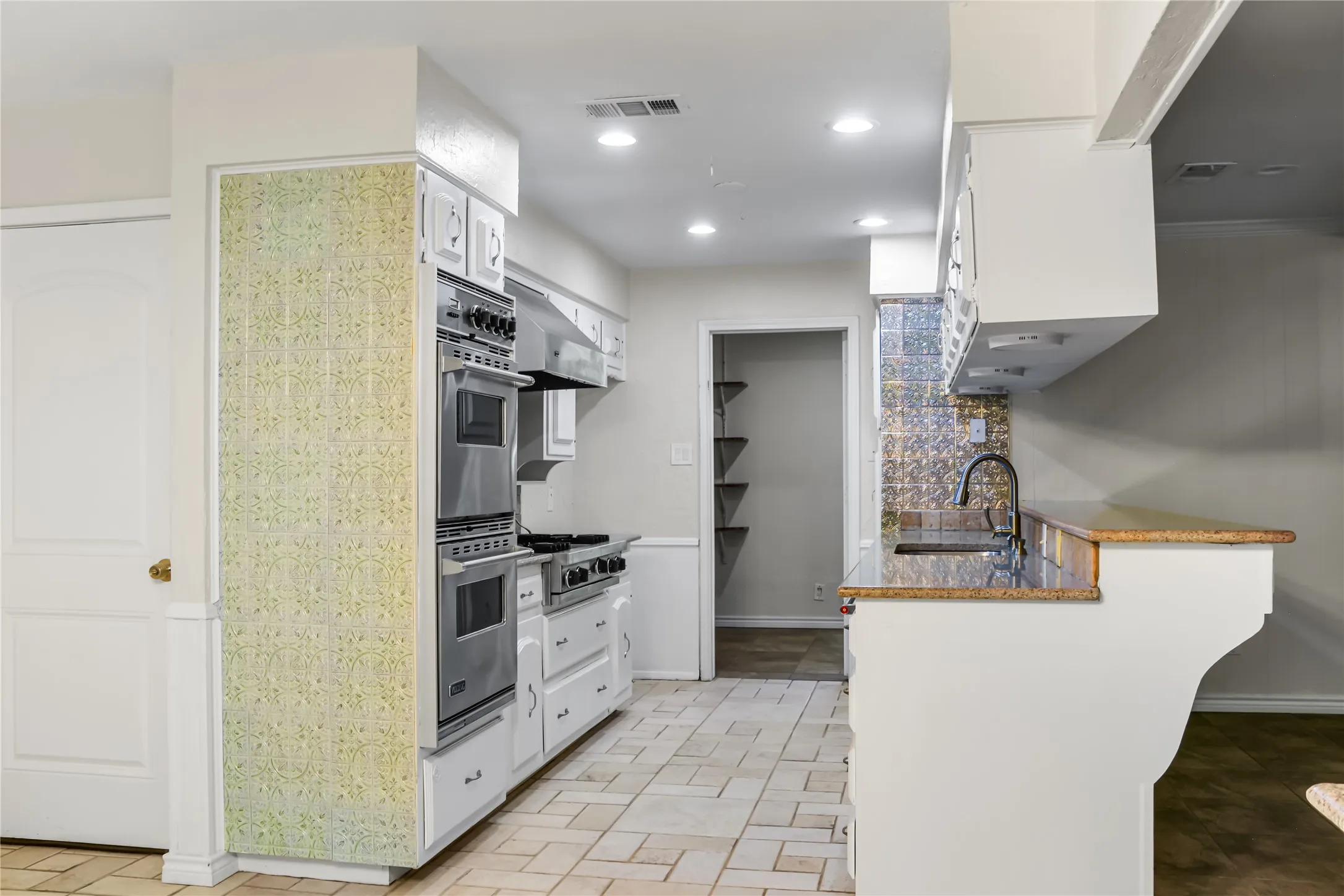 Kitchen looking into extra large pantry
