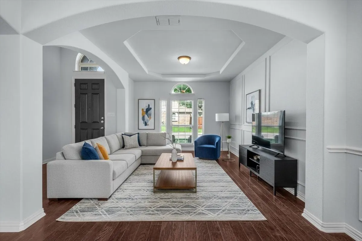Formal living space with arched doorways. **This image has been virtually staged.**
