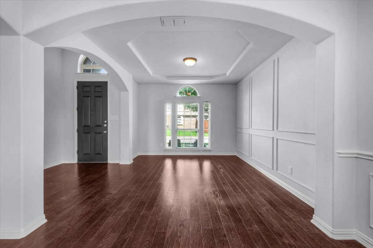 A spacious formal living room welcomes you just off the entry, featuring beautiful natural light and views of the front of the home.
