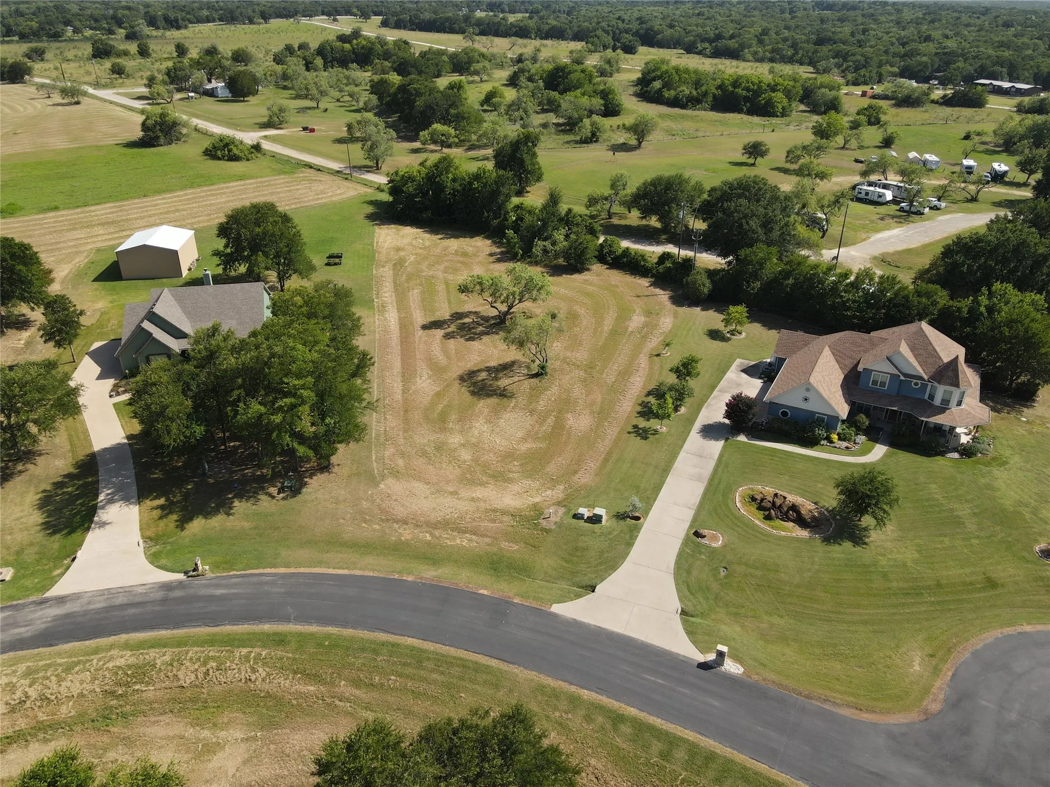 Spacious property featuring two distinct homes, each with a private concrete driveway