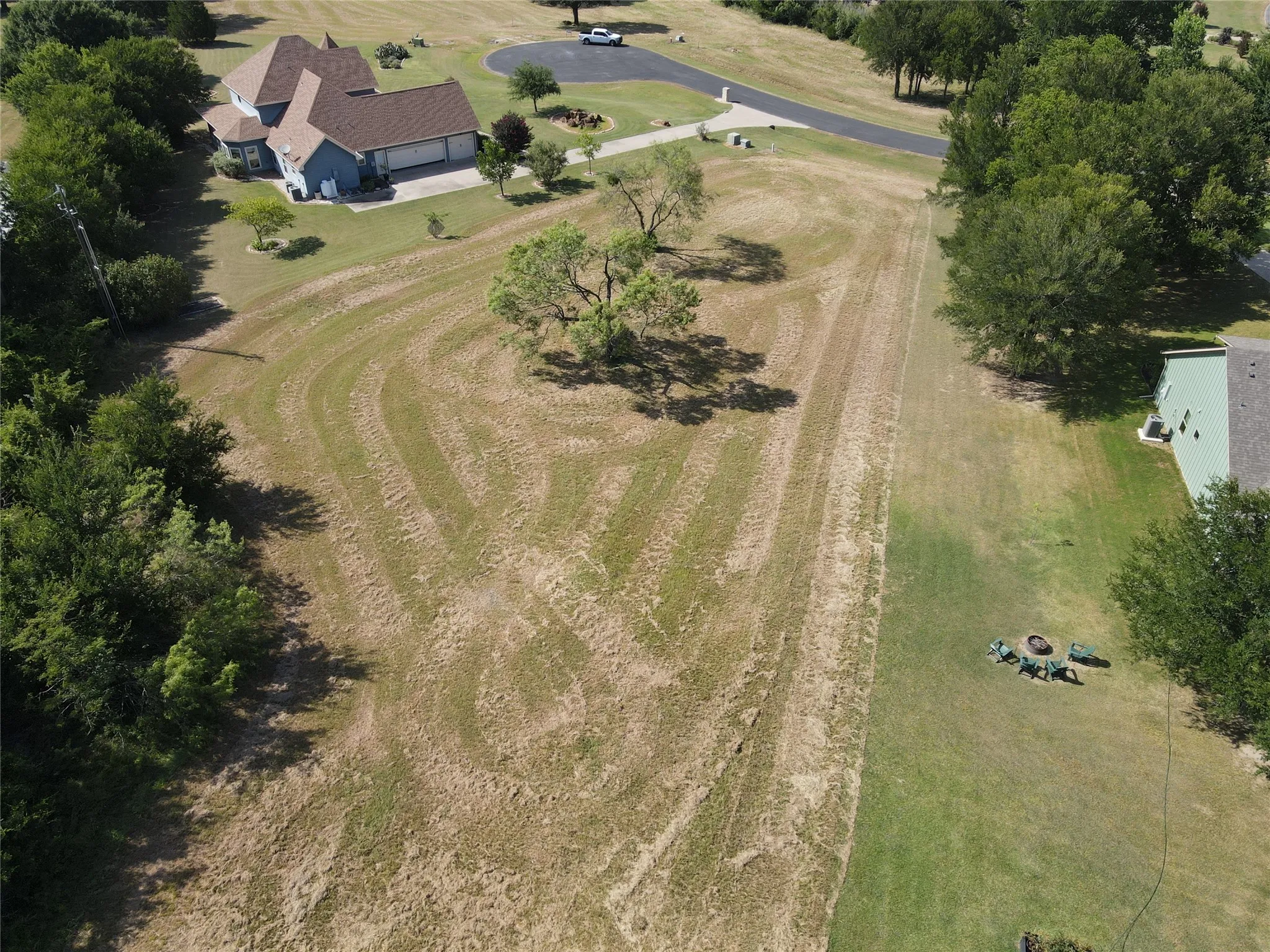 Expansive land parcel featuring existing tree growth and a partial clearing