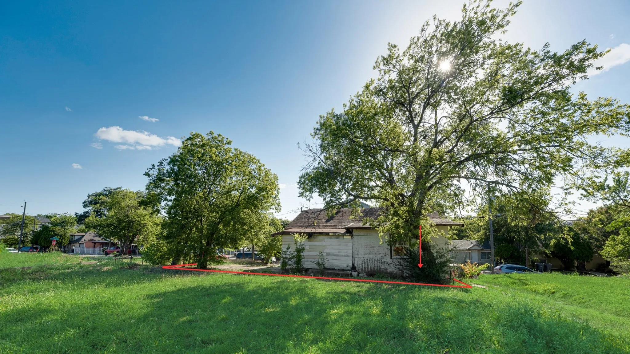 Behind left side of home.