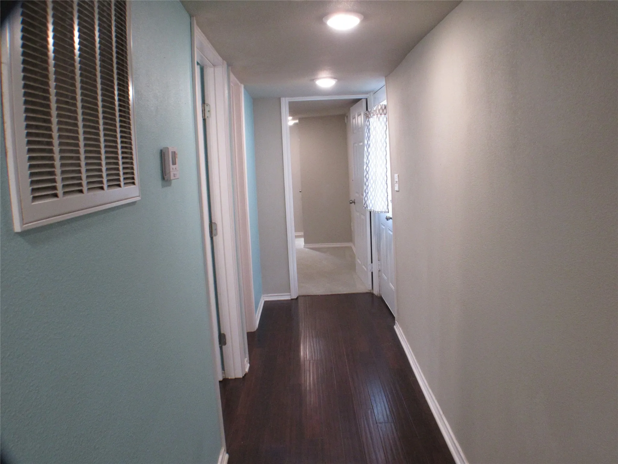 Not quite as long as it looks. Doorway to the laundry room is on the left.