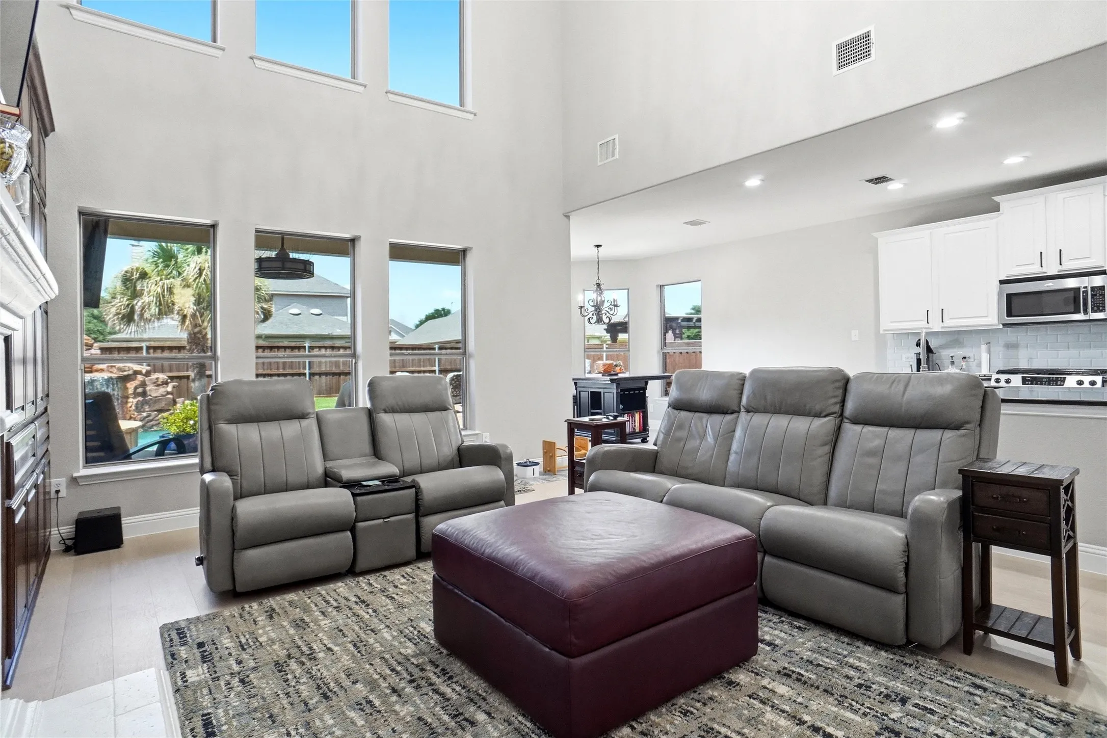 Two-story living area with high ceilings and light-toned walls
