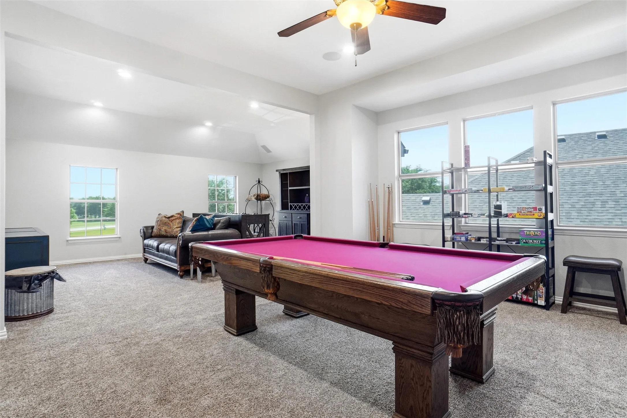 Spacious bonus room featuring vaulted ceilings, recessed lighting, and ample natural light from multiple windows