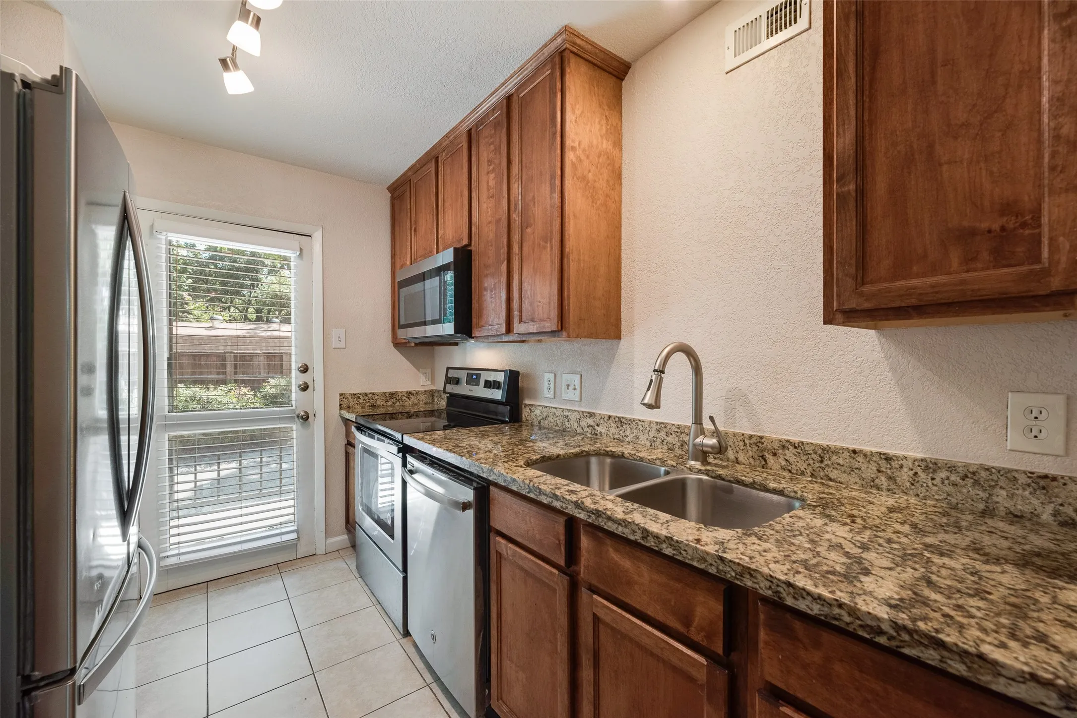 Granite counters with a cozy patio looking into the trees