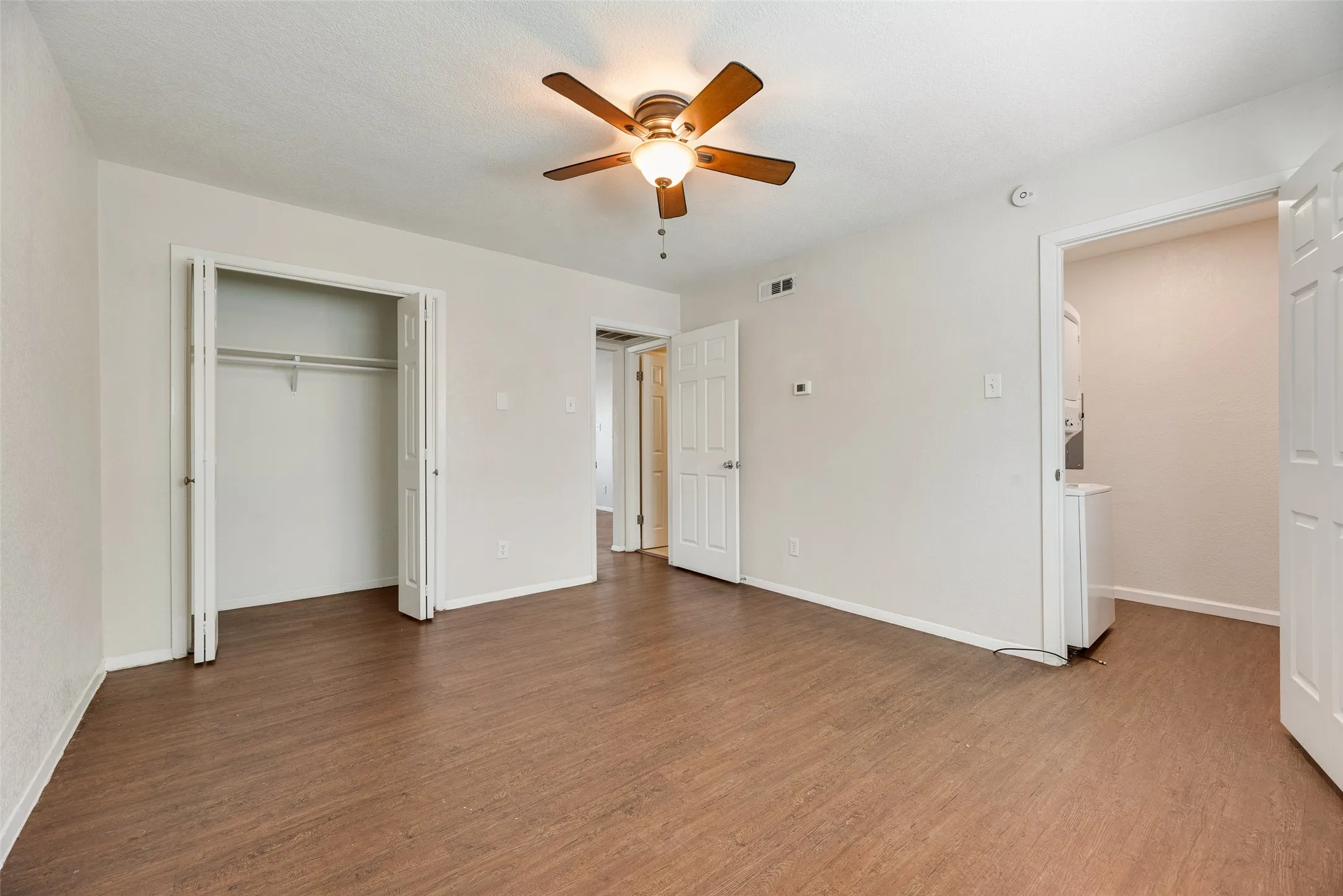 Bedroom with a walk in and reach in closet.