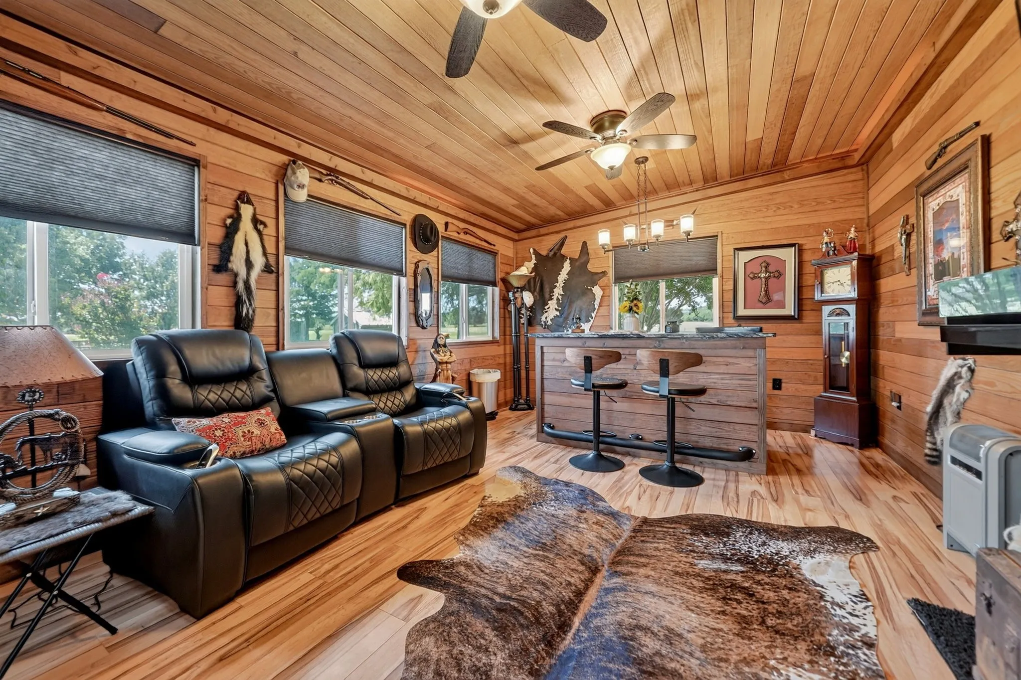 Wood-paneled room featuring a built-in bar
