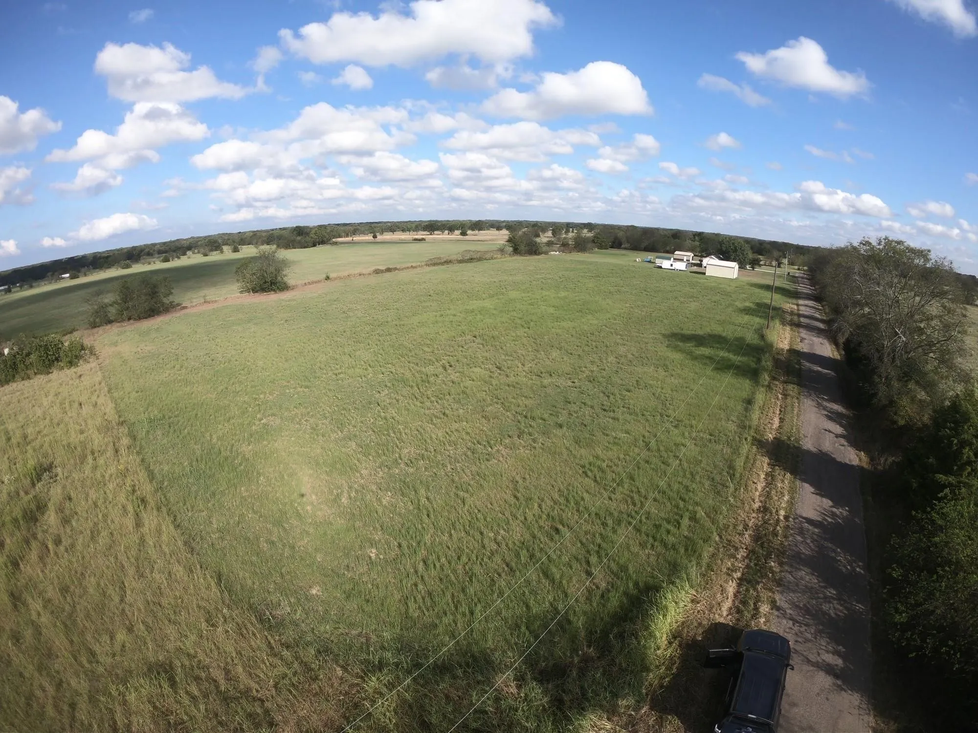 Previous drone shot of the 5 acres, the grass needs to be mowed at this time.   The two properties can be purchased together or separately.   MLS # 21321054 is the 5 acres.