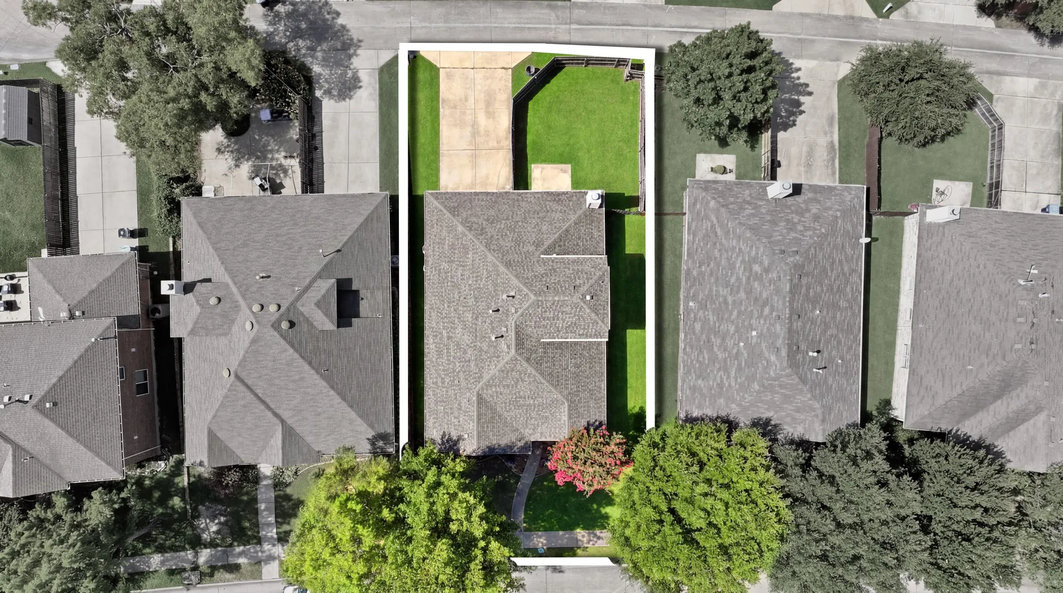 Aerial perspective highlighting a residential property with a multi-gabled roofline