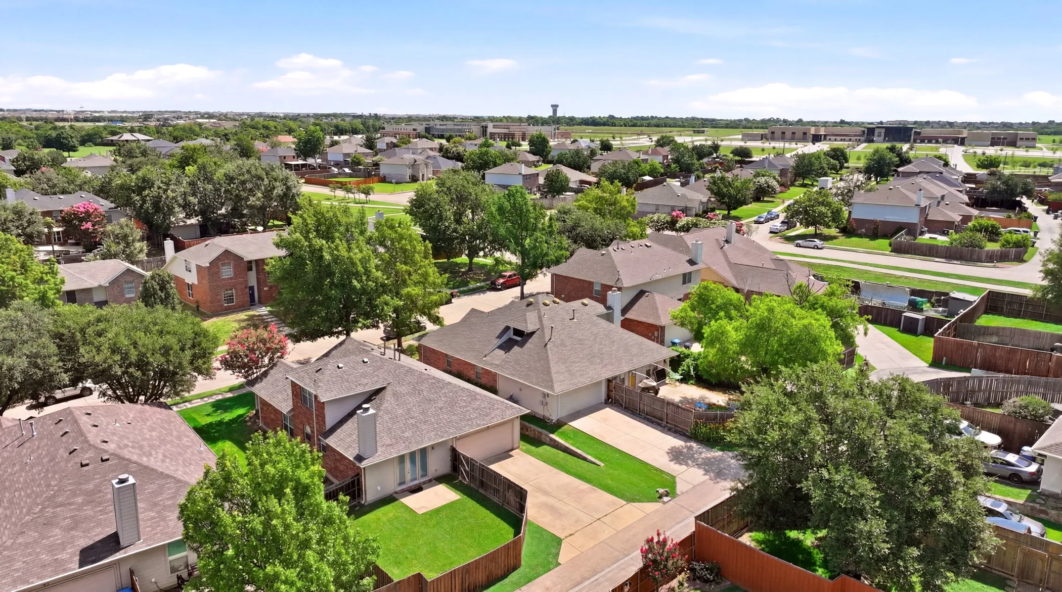 Aerial perspective showcasing a residential neighborhood with a mix of single-story and two-story homes