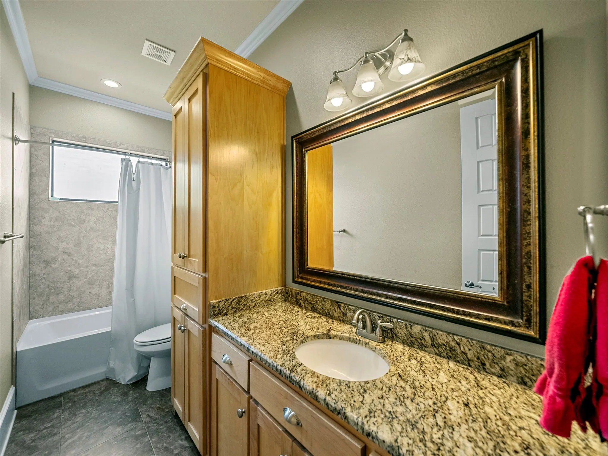 GUEST BATH...Tile Floor, Granite Vanity Top, Tub/Shower Combo, Linen Cabinet